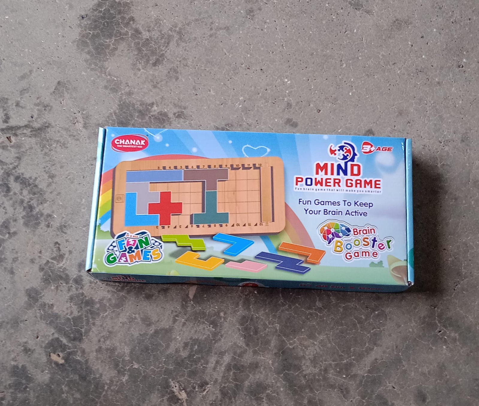 Toddler playing with the wooden mind game, focusing on problem-solving.