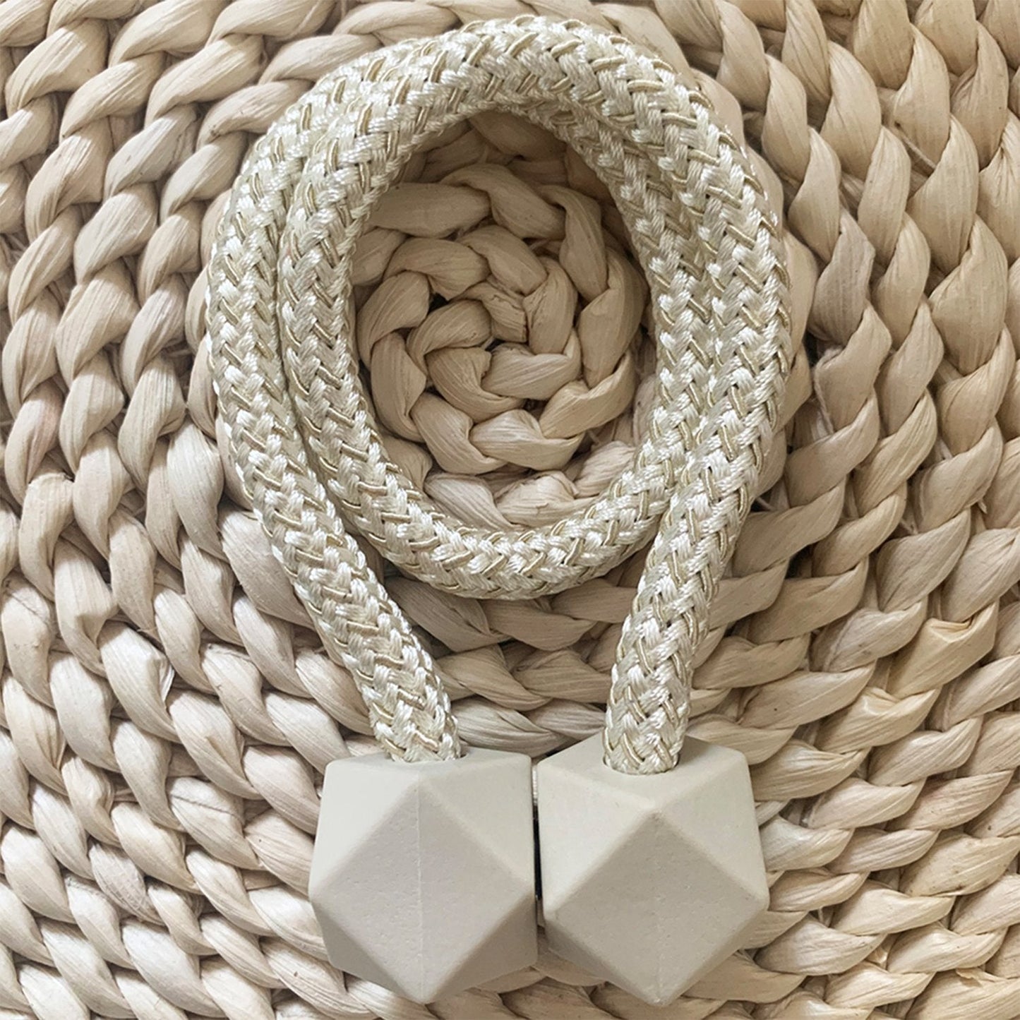 Pair of hexagonal magnetic curtain tiebacks elegantly holding a sheer curtain.