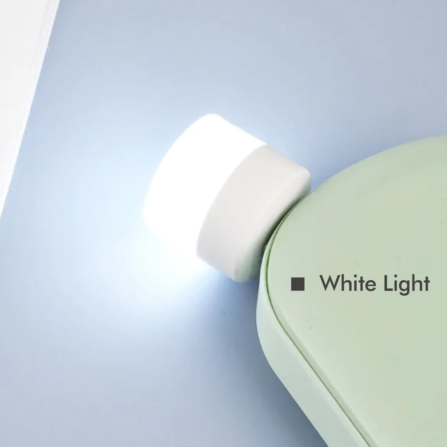 A bright USB bulb providing ambient light for a desk setup in an office environment.