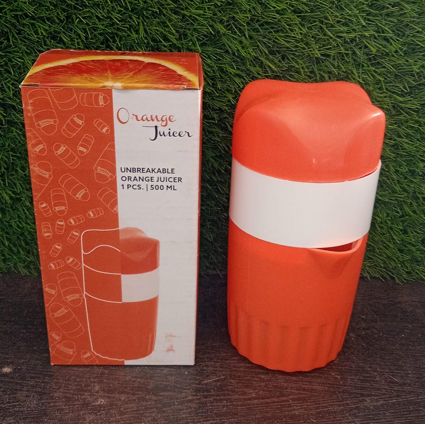 Office water bottle next to the manual citrus juicer, highlighting portability.
