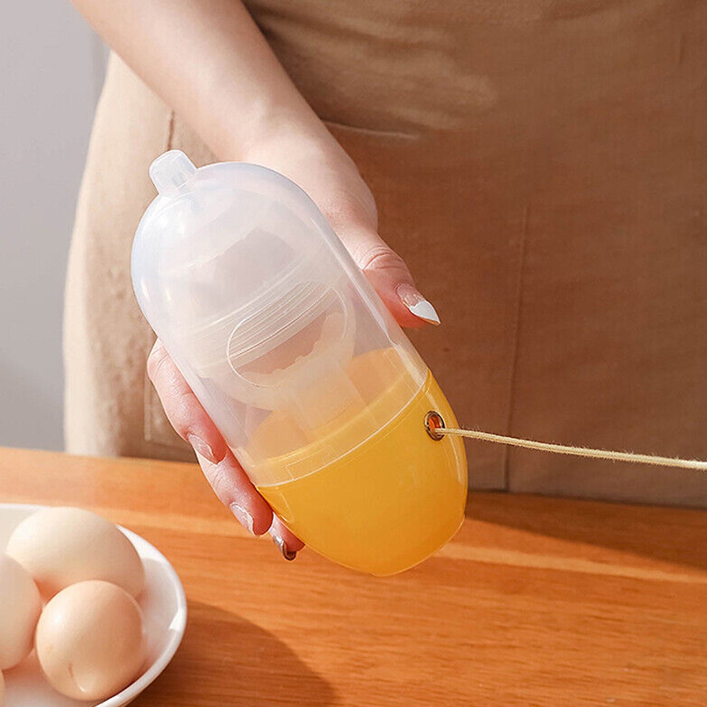 Detailed view of the Manual Egg Scrambler's base and internal components, showcasing its sturdy construction.