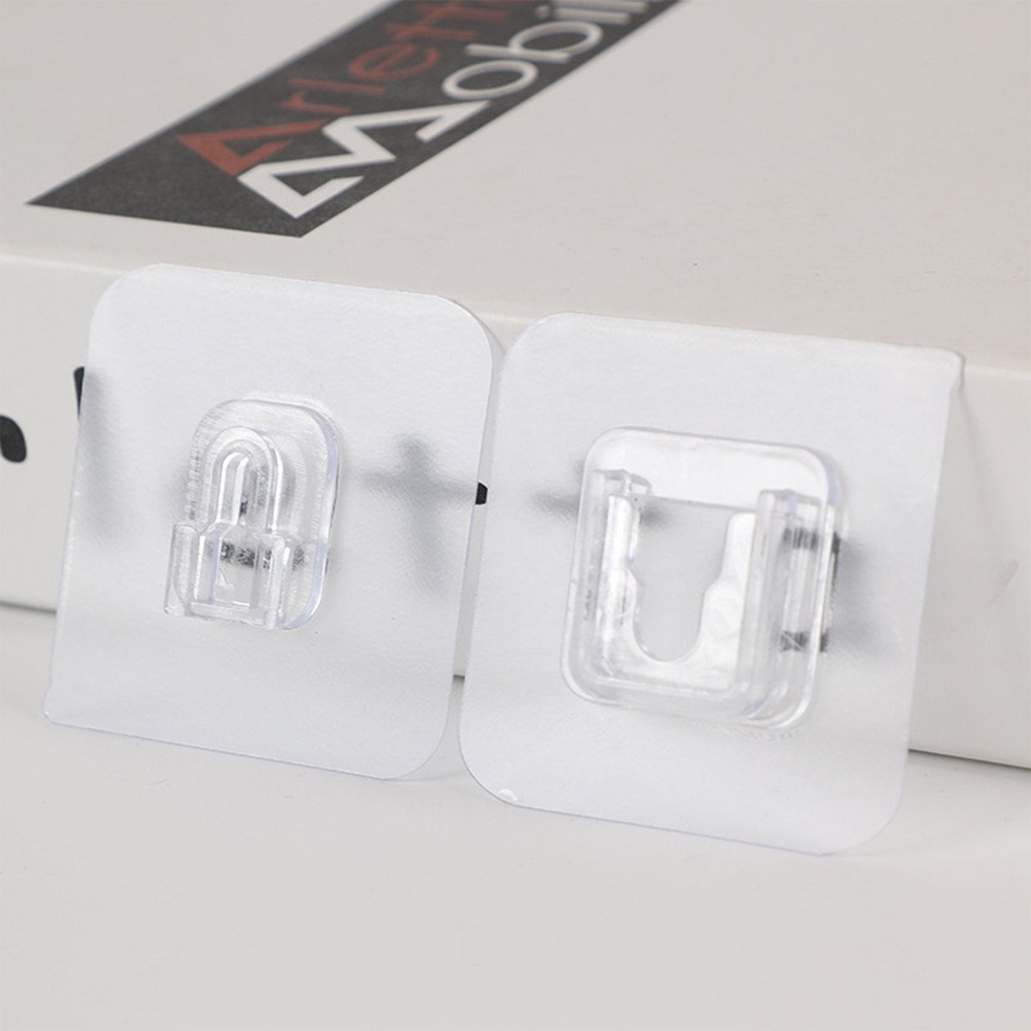 A pack of 20 GlimmerHome heavy-duty adhesive wall hooks shown for drill-free home organization.