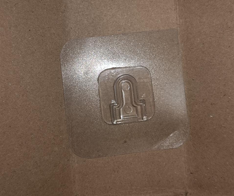 Transparent adhesive hooks neatly packaged for safe delivery.