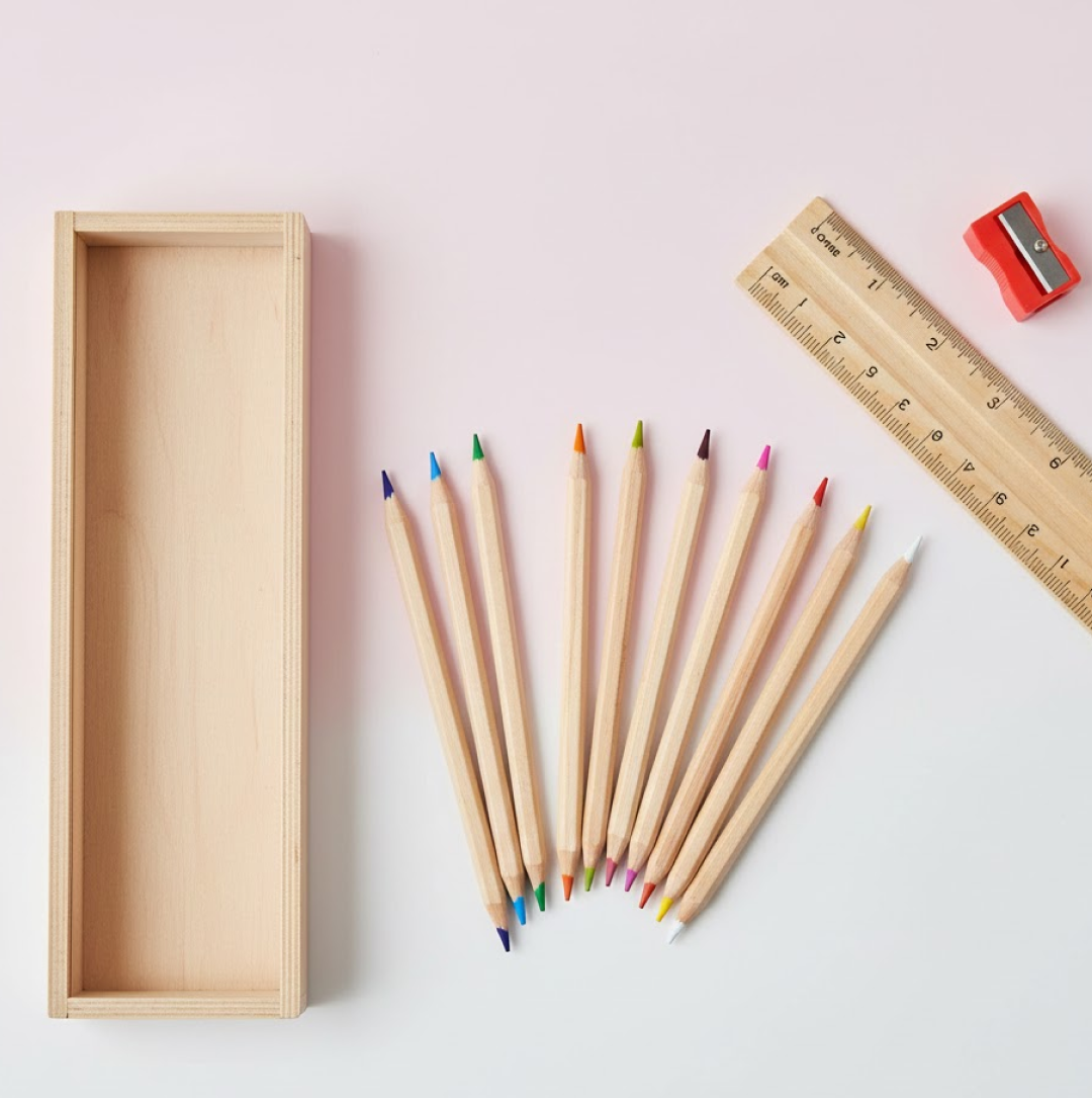 A complete 12-piece wooden pencil set with vibrant colors, a box, ruler, and sharpener.