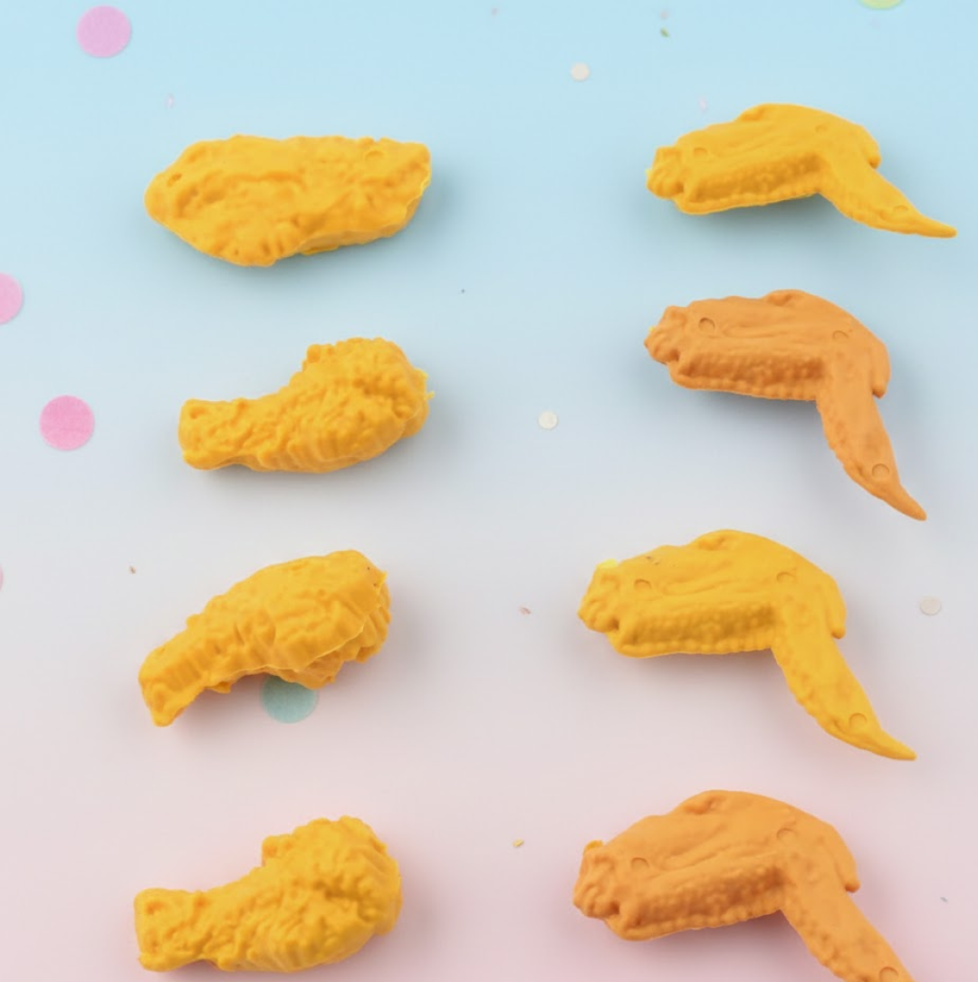 An 8-piece set of fun chicken erasers, featuring both chicken wing and leg shapes, displayed neatly.
