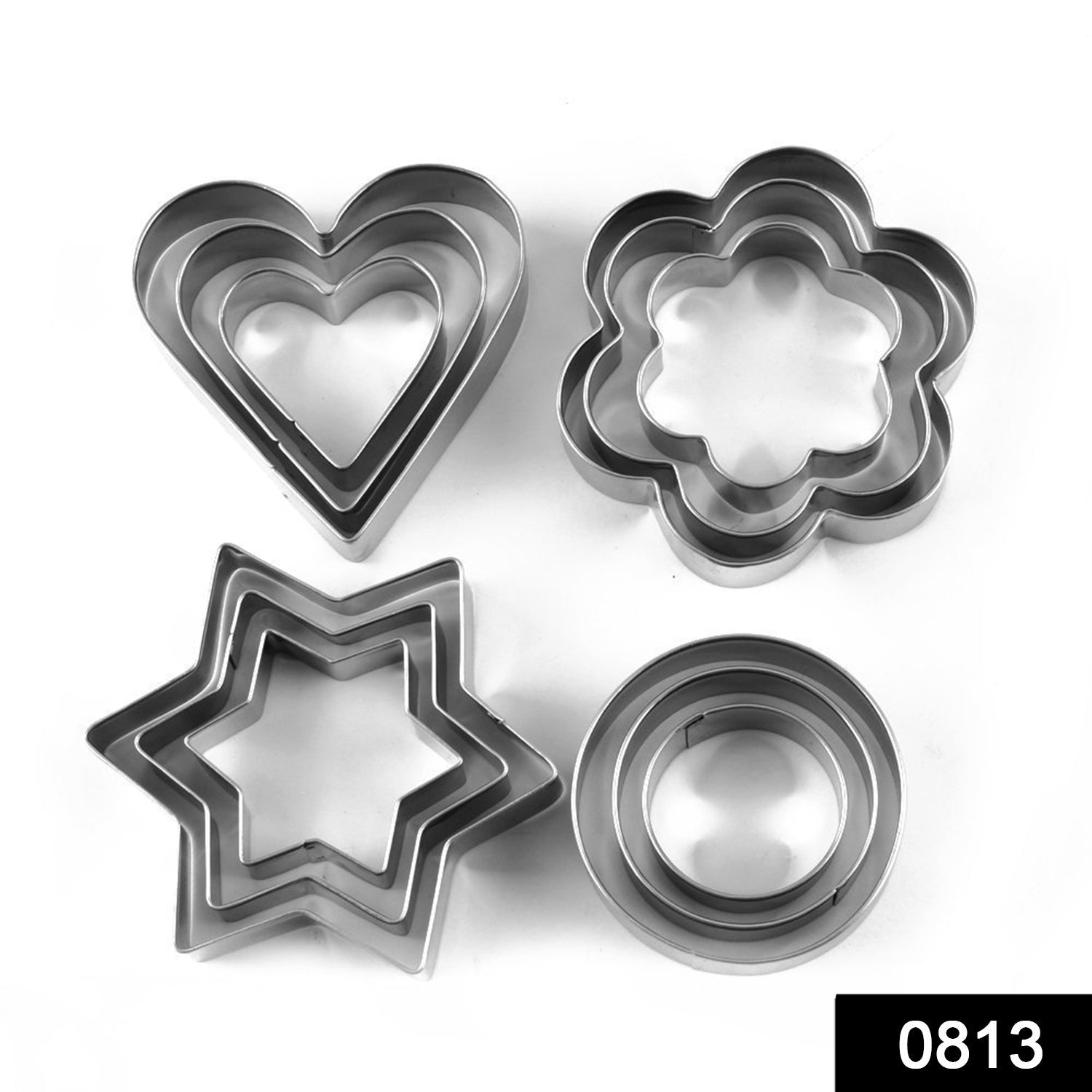 Overhead view of various stainless steel cookie cutters arranged on a surface.