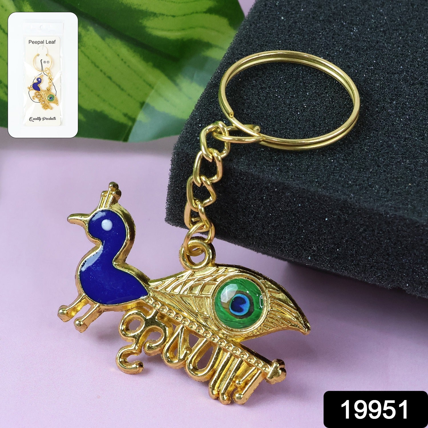 Close-up detail of the golden Krishna Peacock keychain's artistic motif