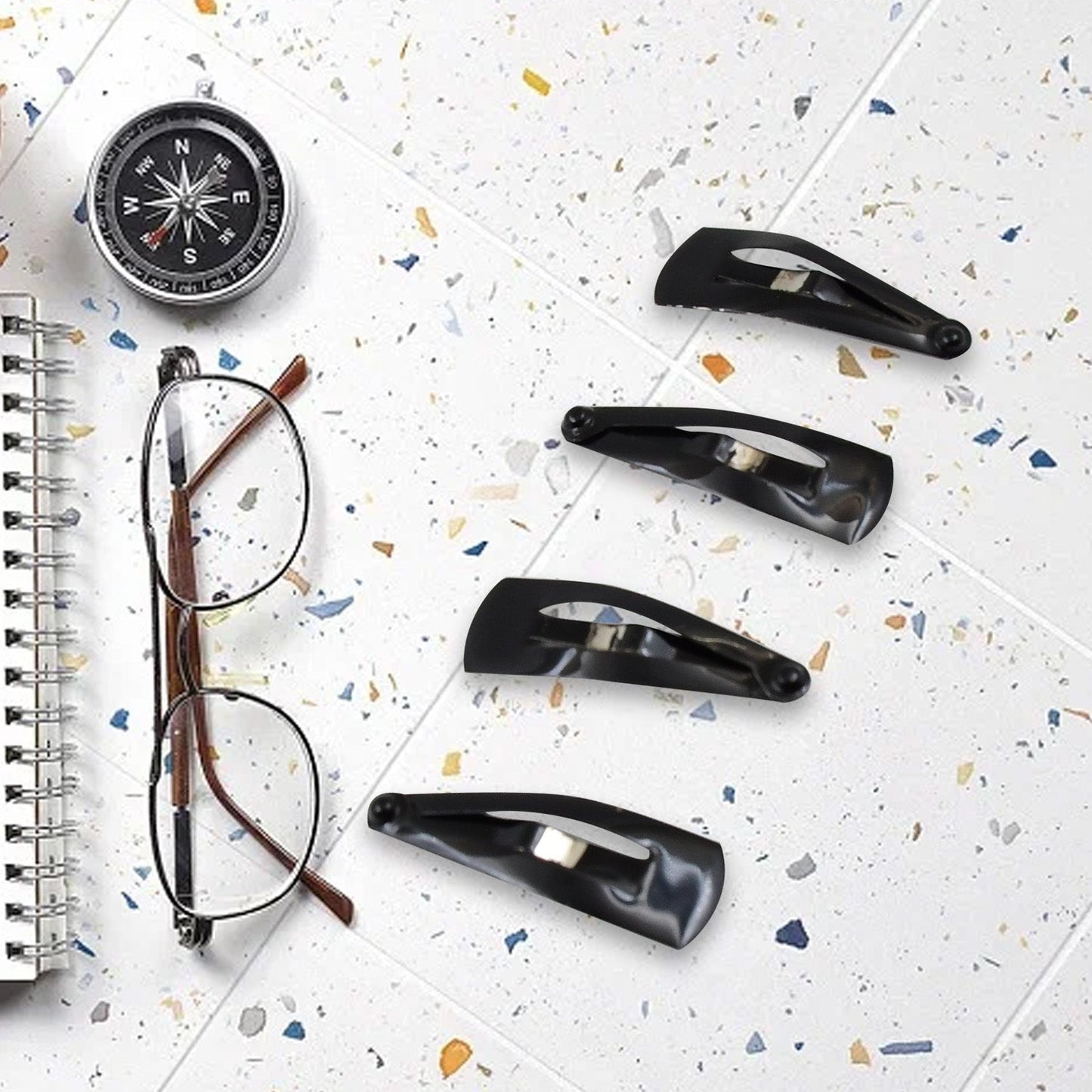Matt black Metal Tic Tac Hair Clips on a neutral background, showcasing their sleek design.