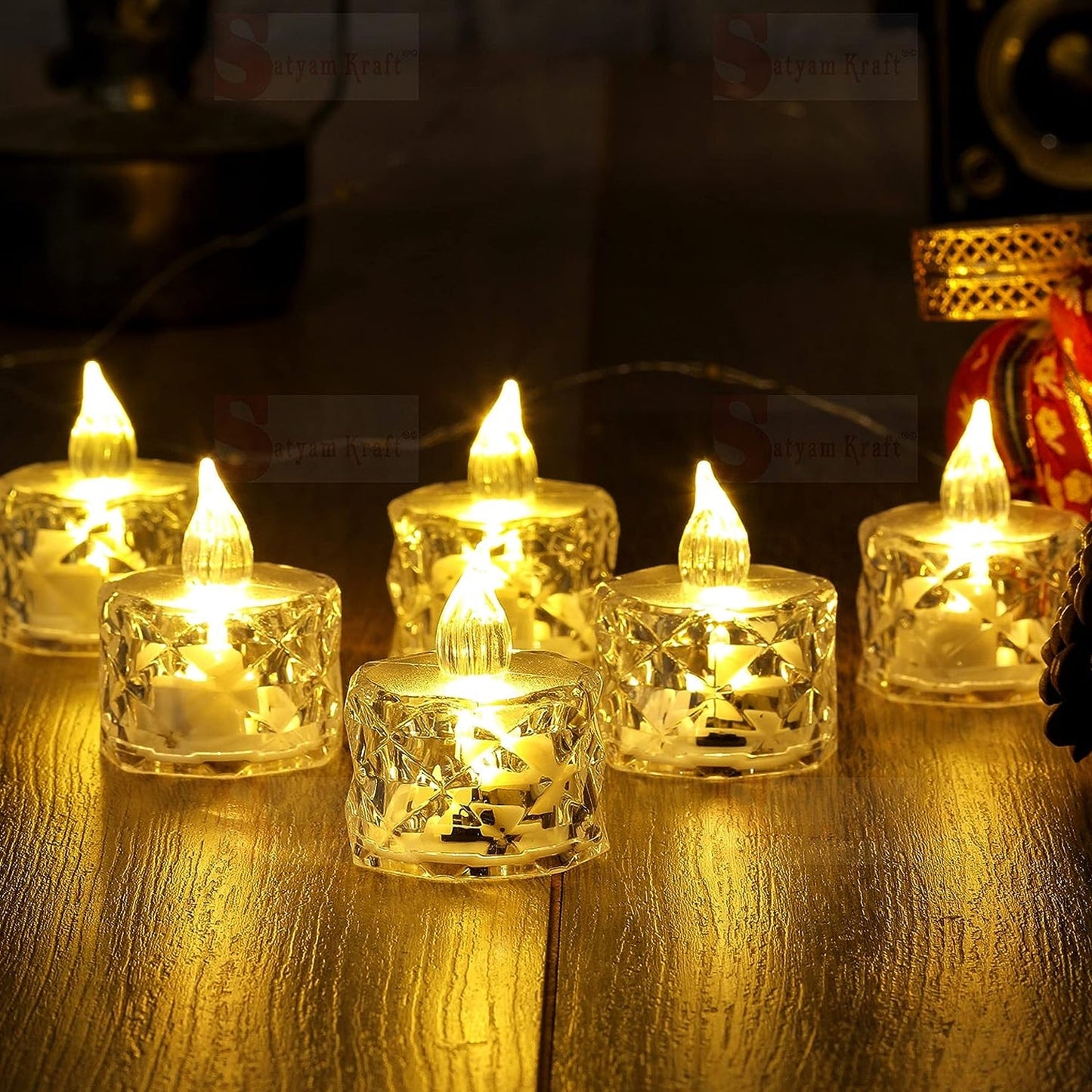 Multiple acrylic flameless tea lights glowing warmly in a home setting.