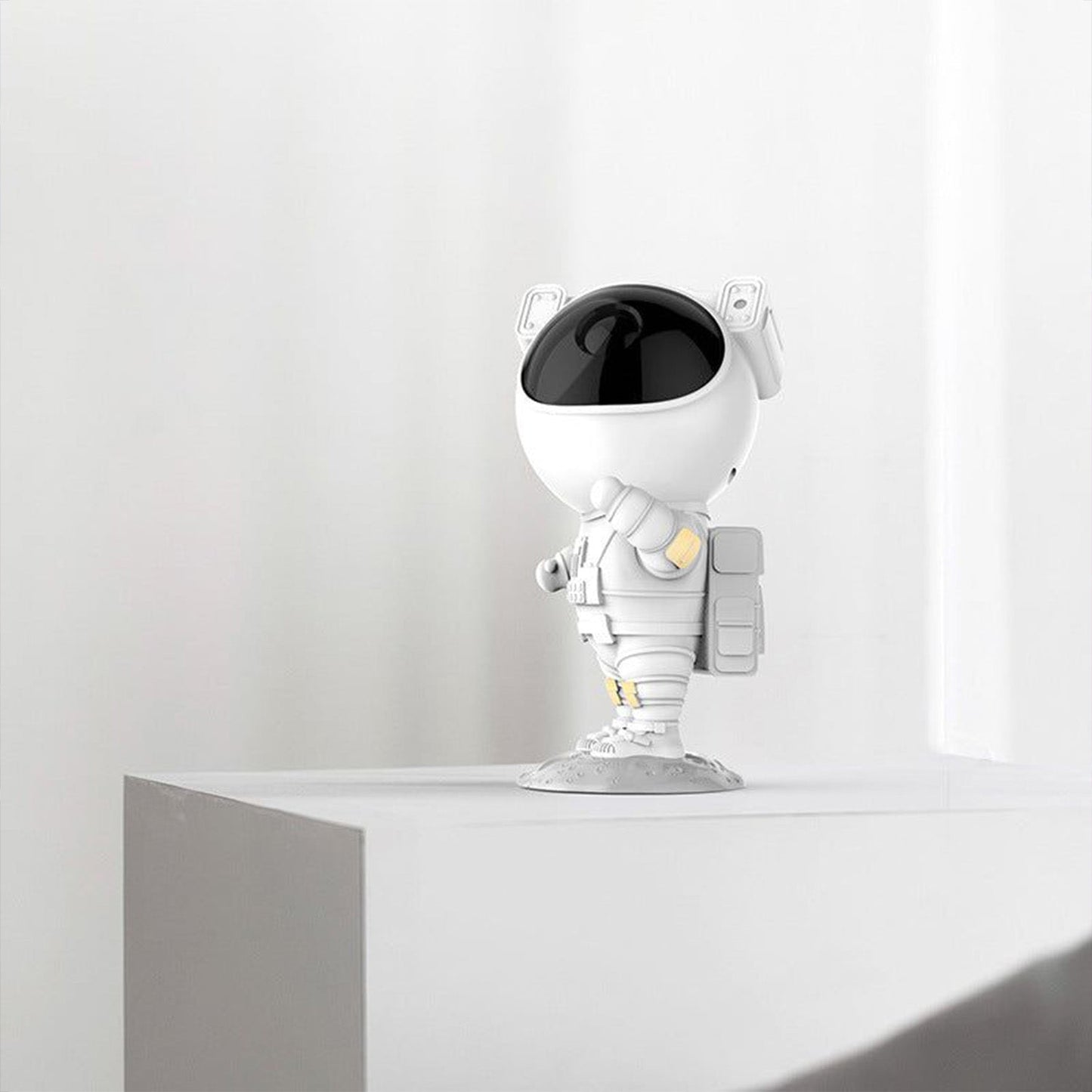 Side view of the astronaut night light lamp projecting a calming starry ambiance.