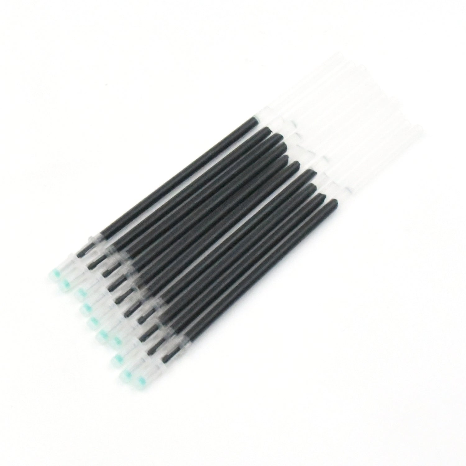 Multiple InkGlow black pen refills arranged neatly on a surface.