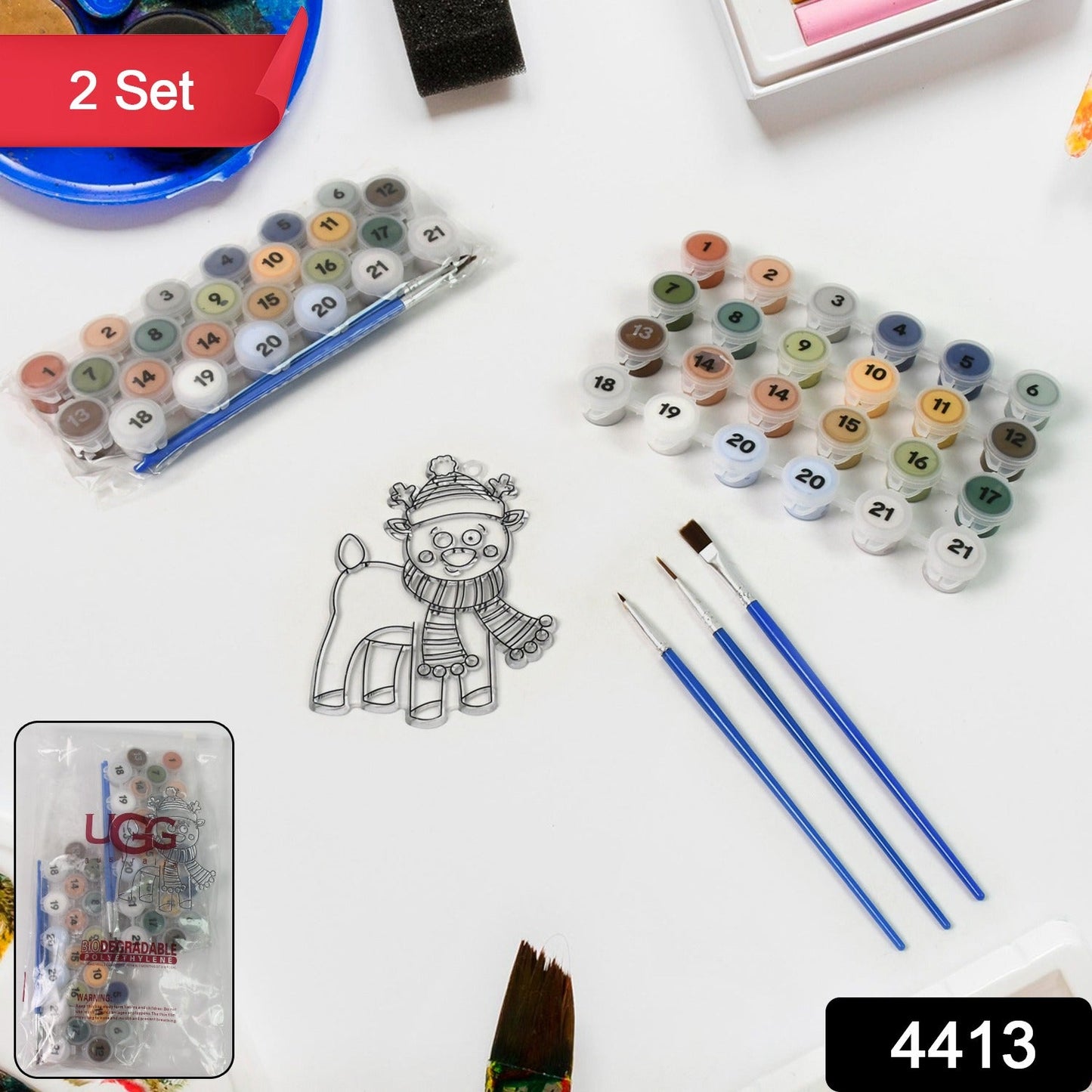 Close-up of the 21 numbered acrylic paint colors and fine brushes included in the art kit.