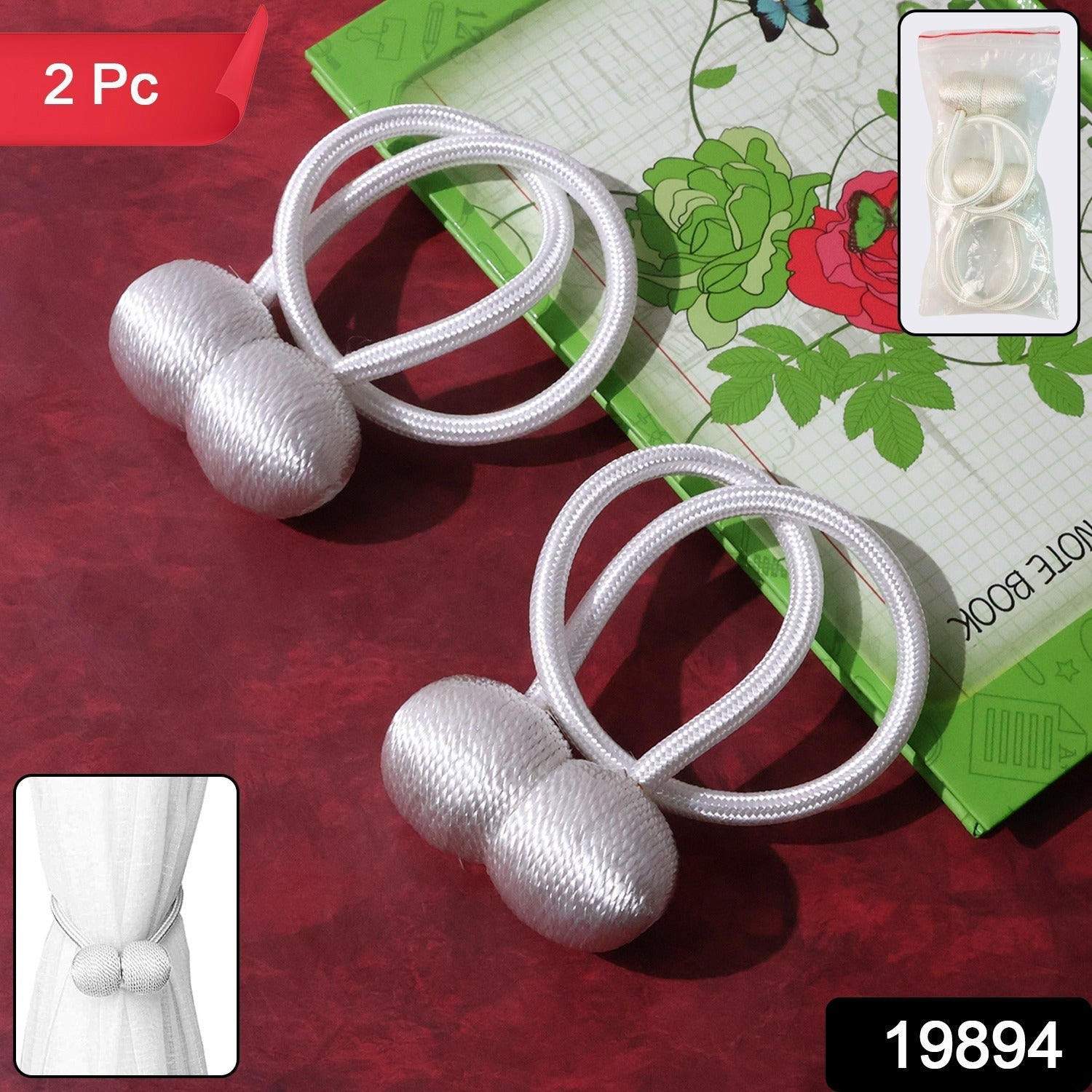 Close-up of the braided rope and magnetic ball of a silver curtain tieback.