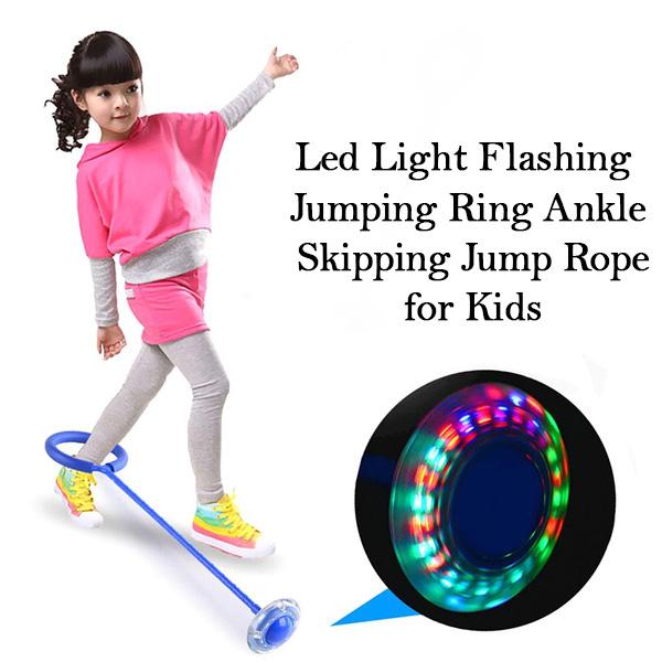 Brightly lit LED ankle skipping rope used for fun exercise on a sunny day.