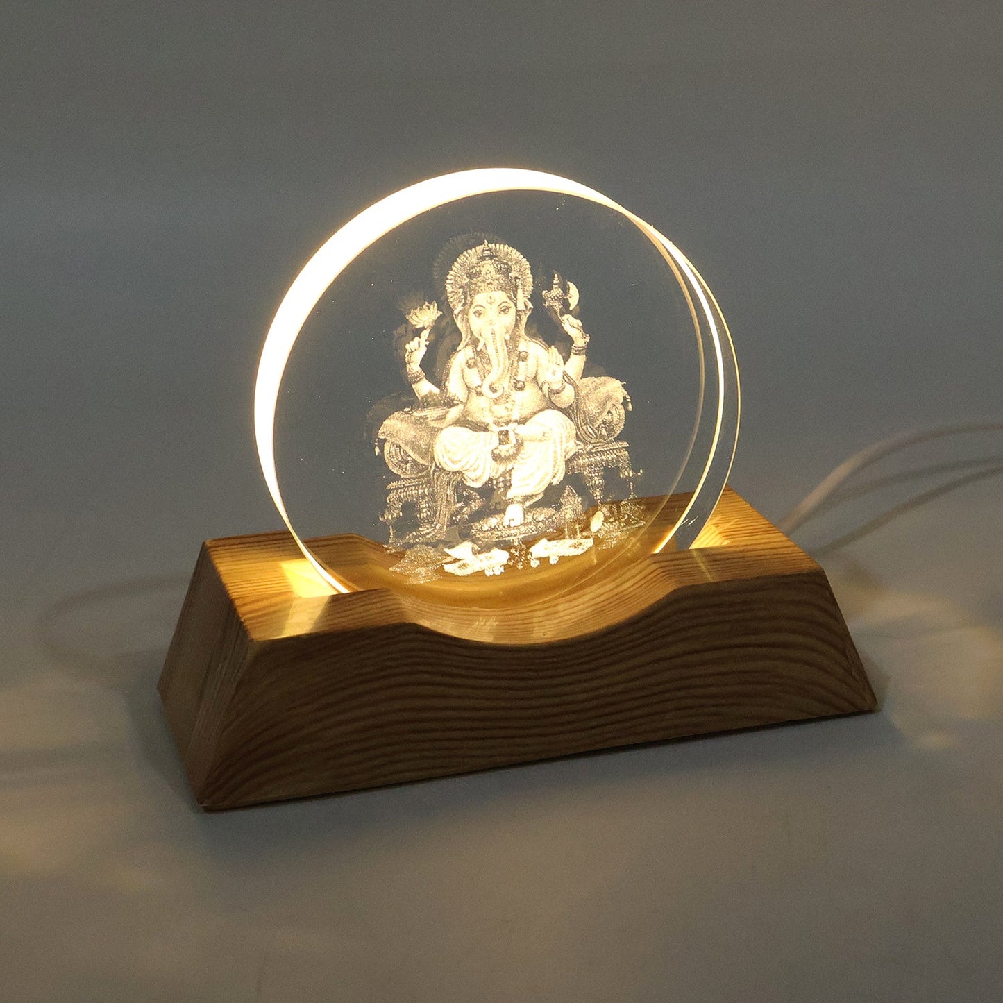 3D Lord Ganesha LED lamp emitting warm light in dim room