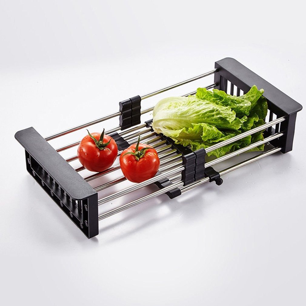 Expandable stainless steel dish drainer over a modern kitchen sink.