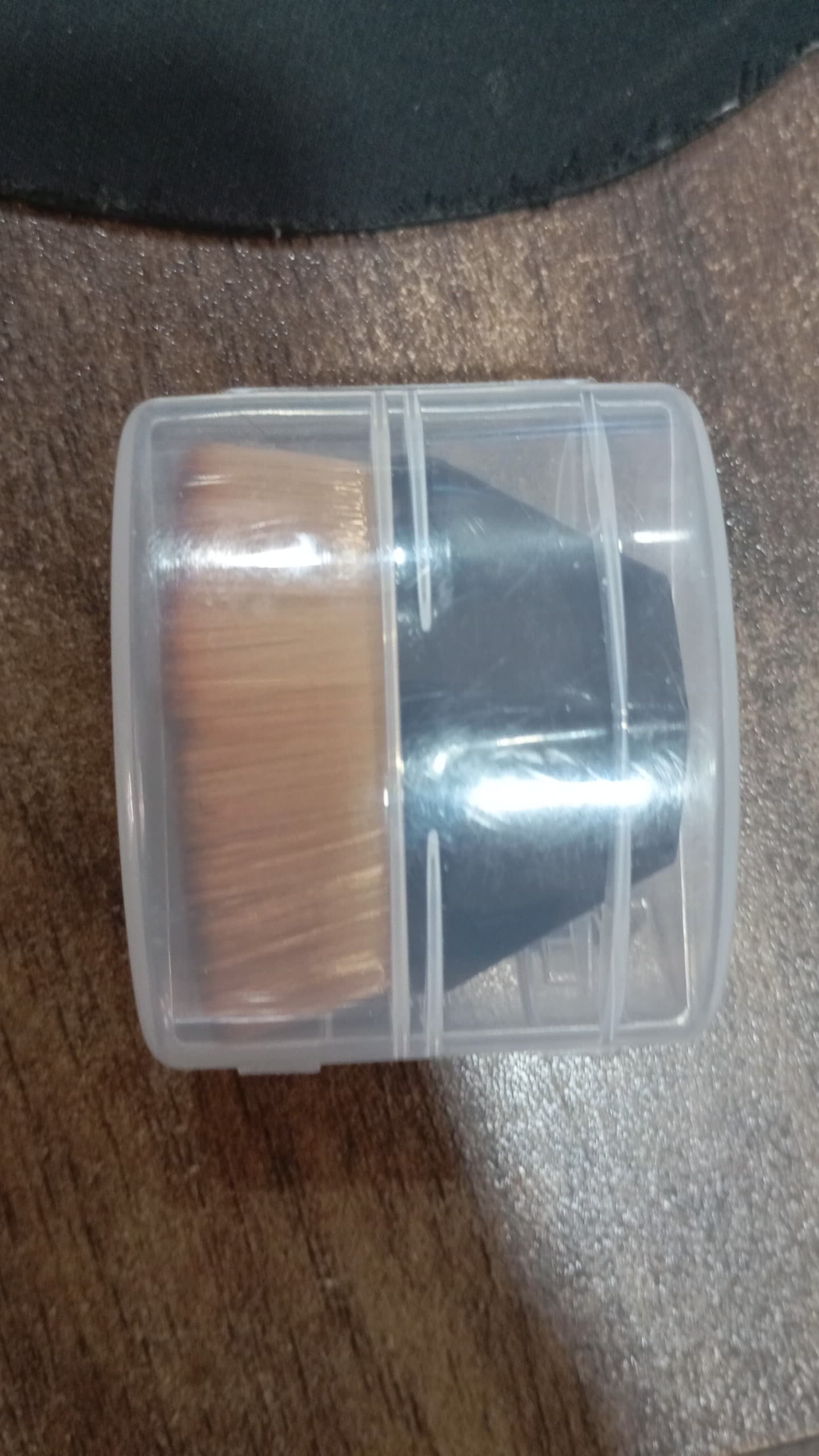 BeautyBare foundation brush neatly stored inside its round, portable protective case.