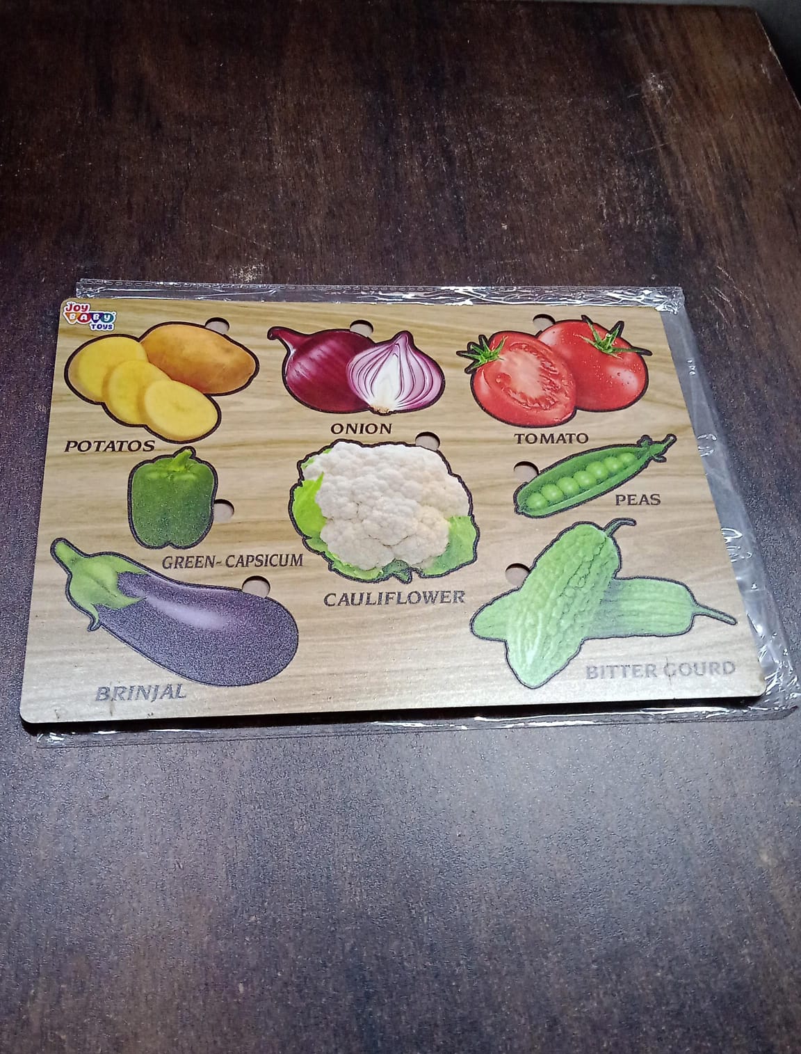 Close-up of smooth, chunky wooden vegetable puzzle pieces, safe for little hands.