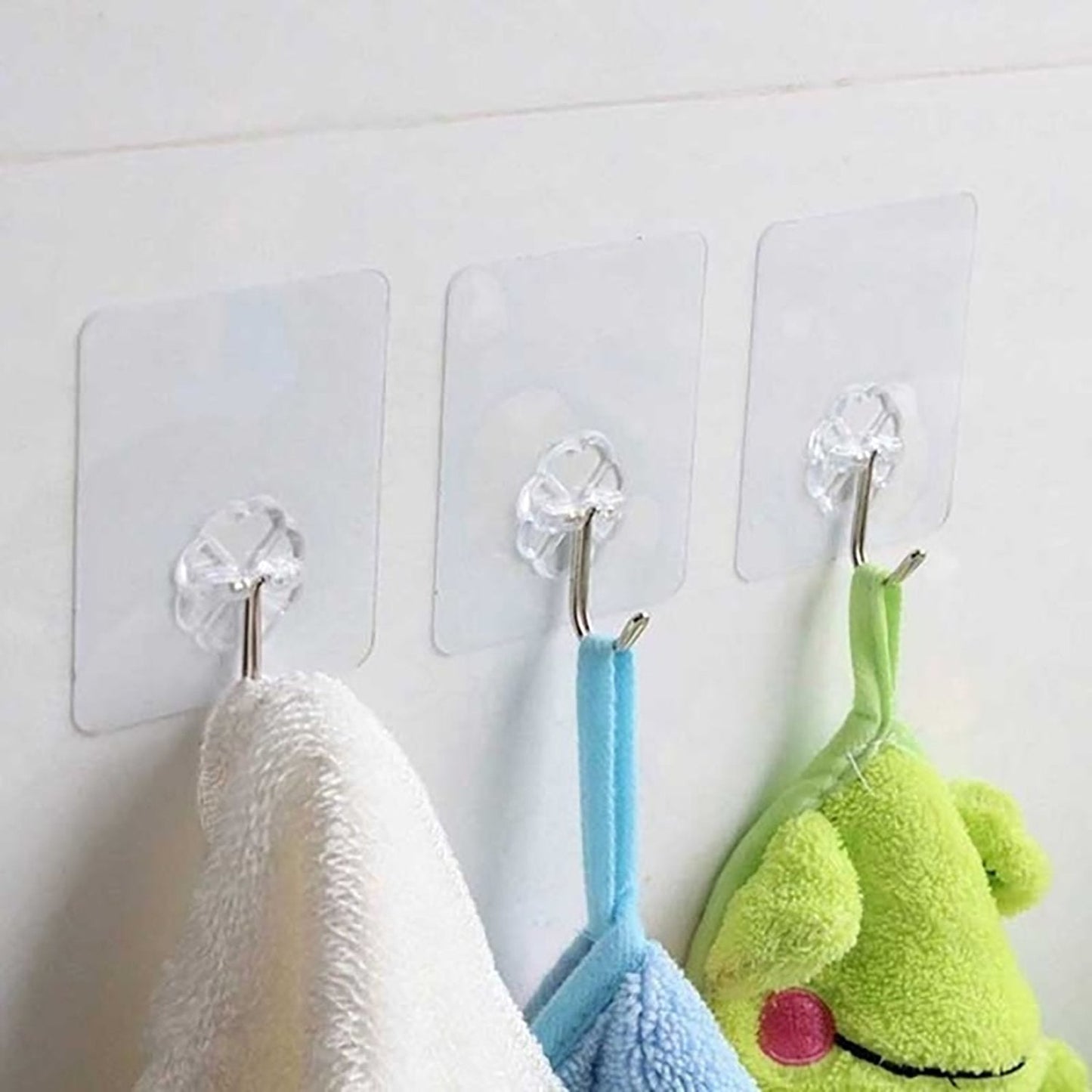 Set of stainless steel adhesive hooks displayed for kitchen organization.