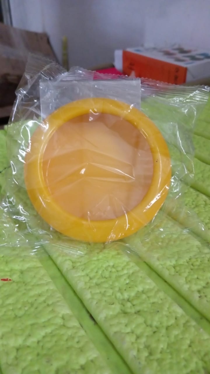 Top-down view of a compact yellow produce saver container.