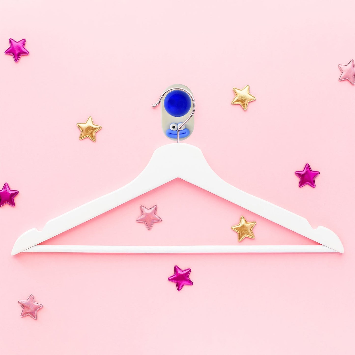 Colorful plastic ball-shaped wall hook holding bathroom towel