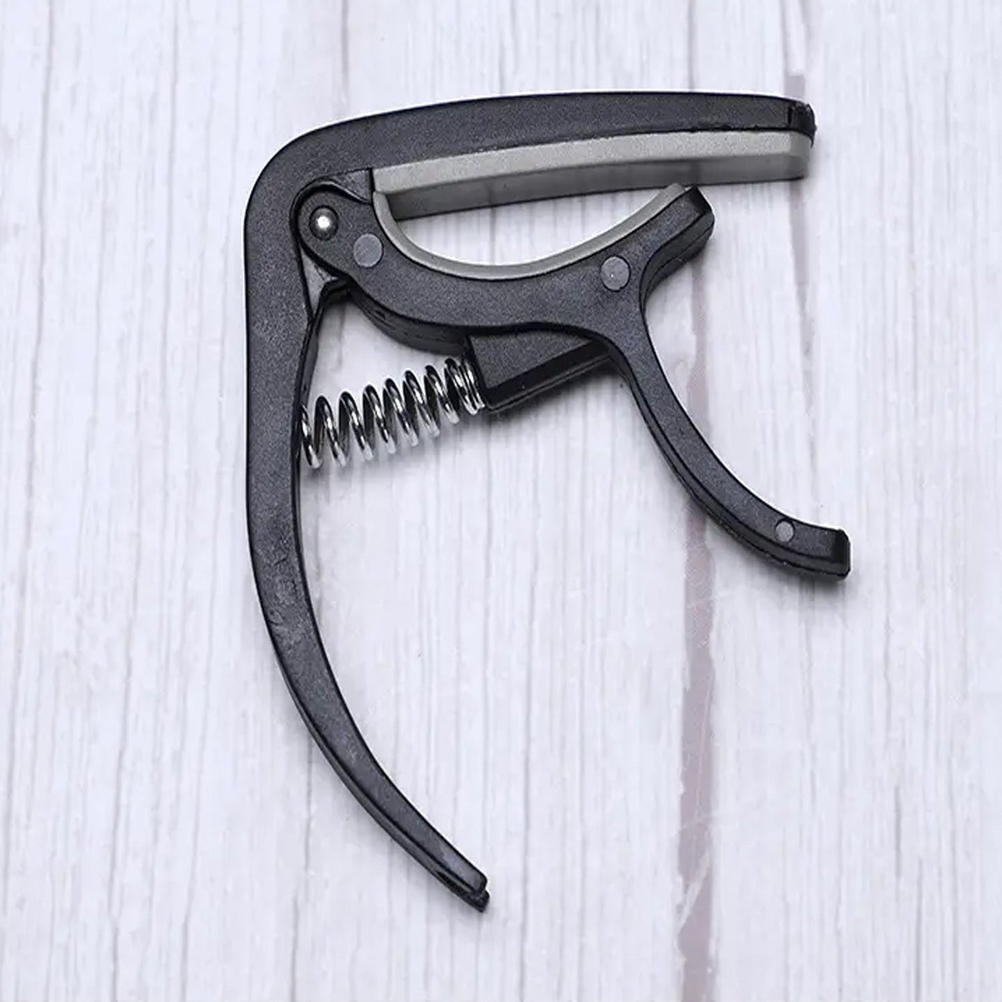 Detail of the Wagtail guitar capo's protective soft pad, preventing instrument damage.