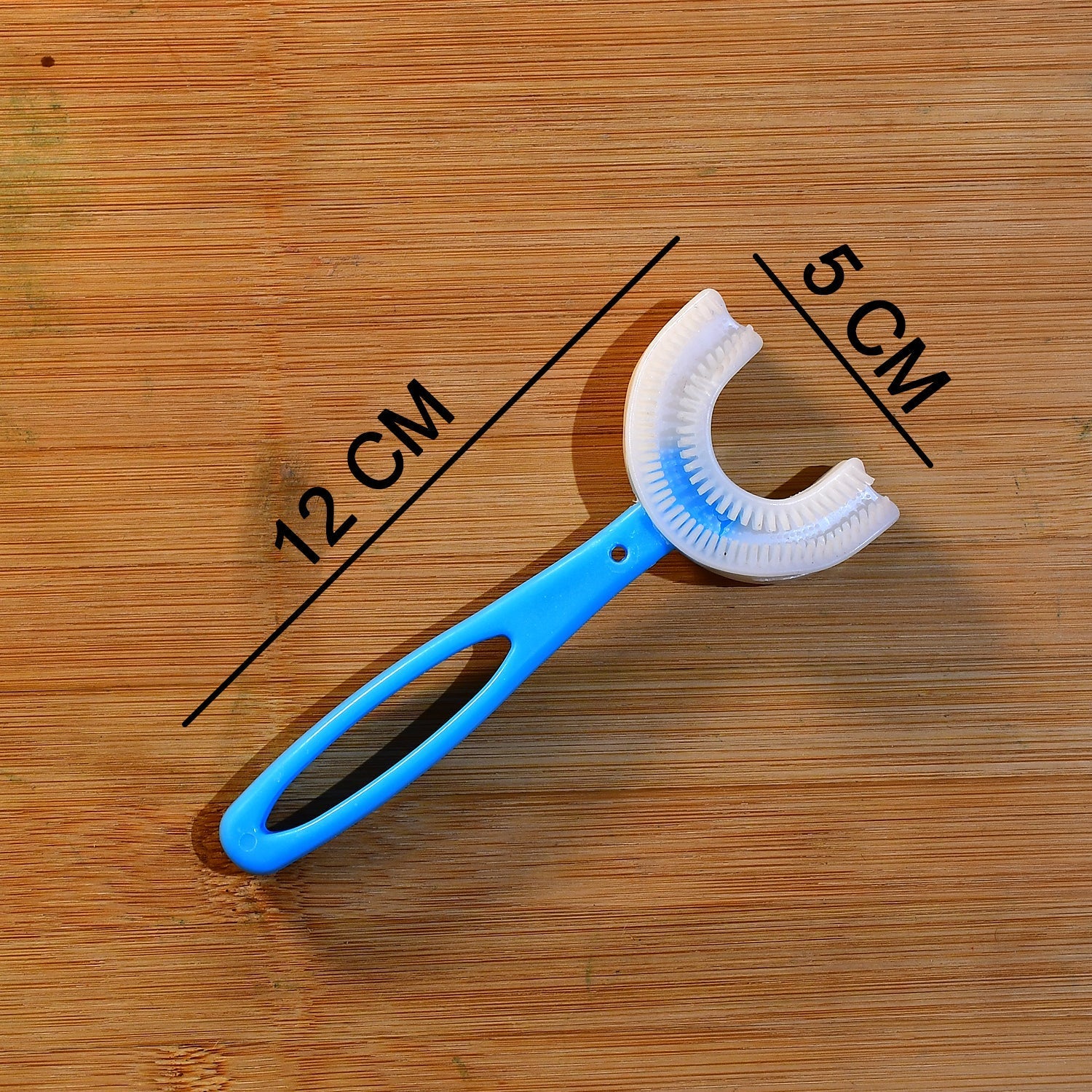 Pink U-shaped toothbrush with a comfortable handle for little hands.