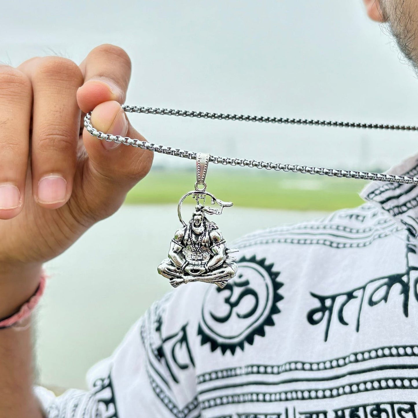 Hanuman Ji pendant displayed with devotional items, symbolizing faith and protection.