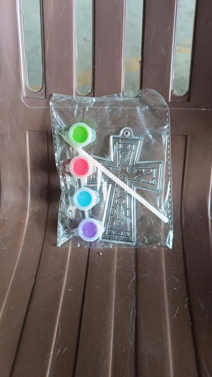 Assorted acrylic paint tubes and a plastic stencil for creative projects.