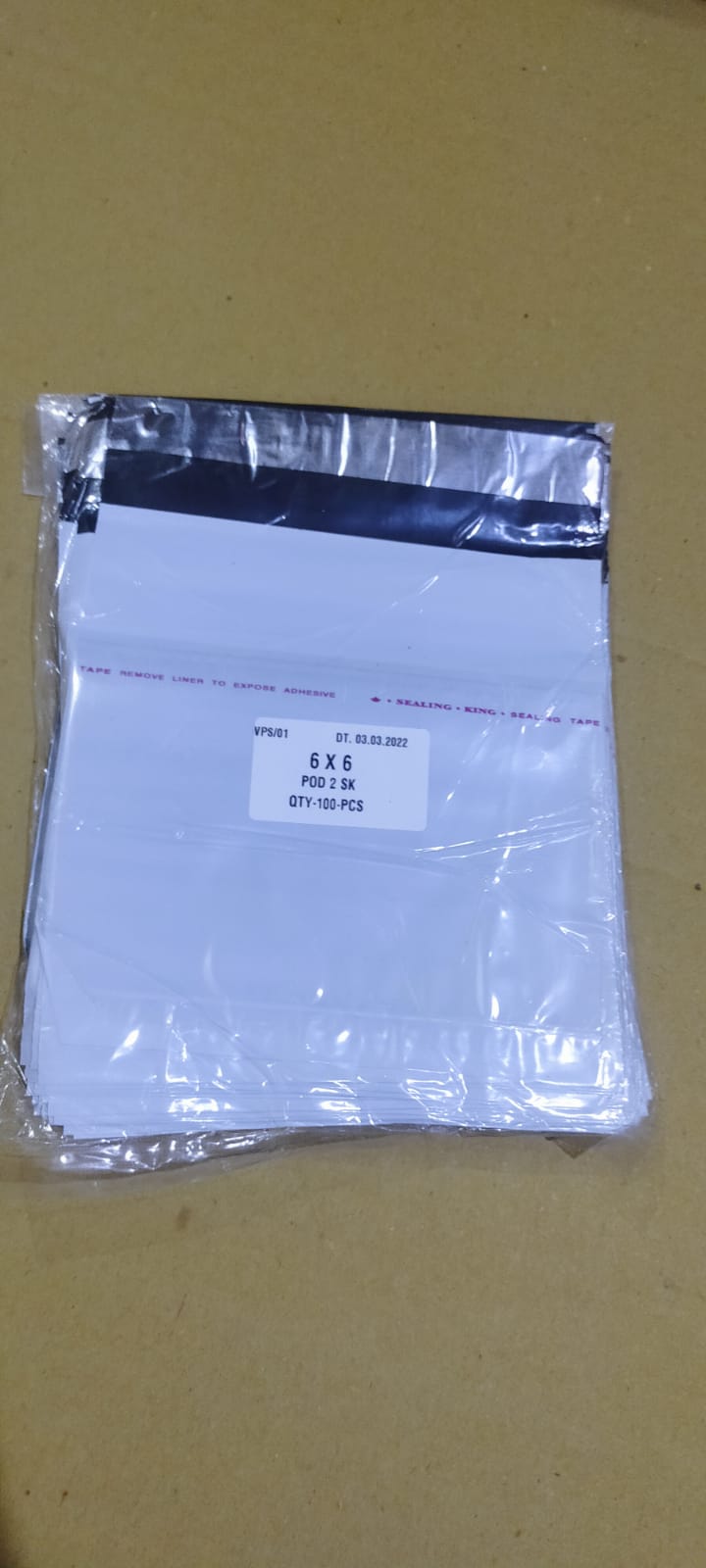 Detailed view of the robust, tamper-proof adhesive seal on a courier bag.