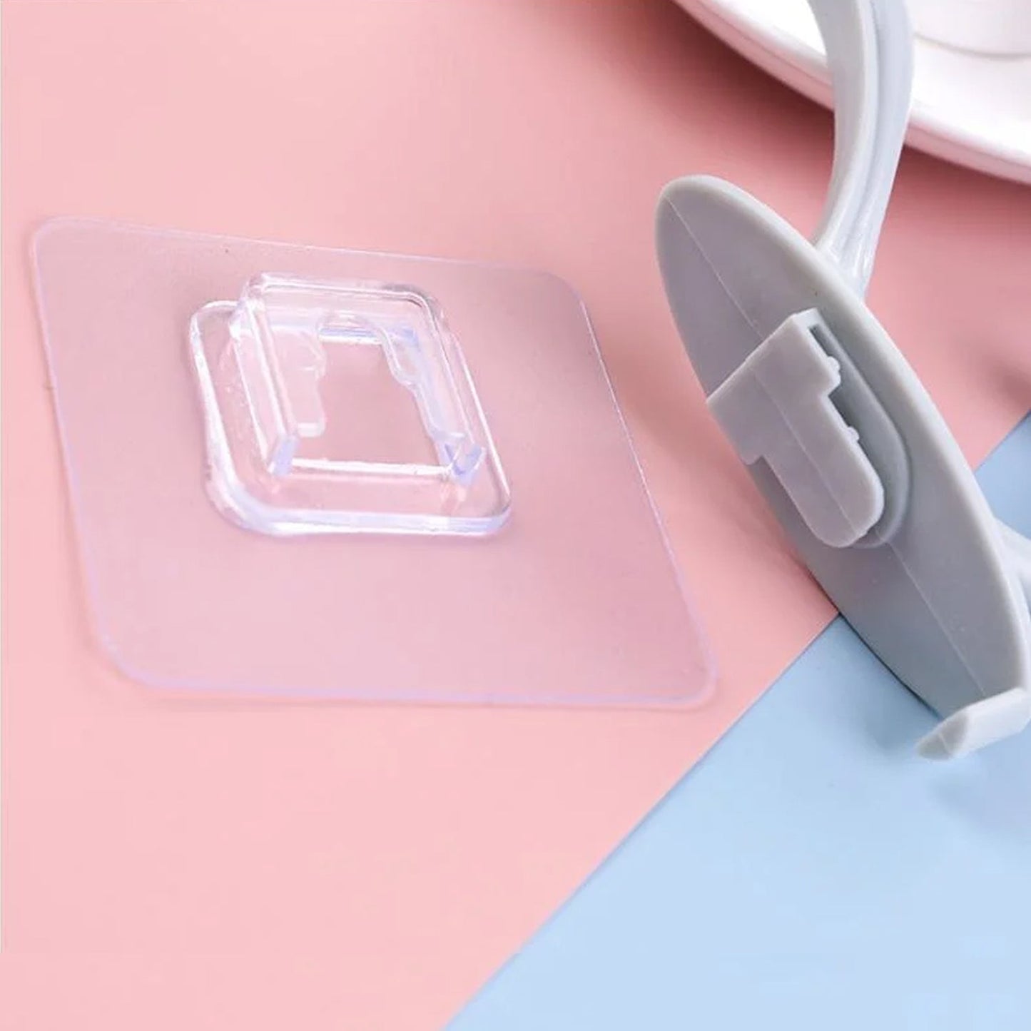 A clear plastic self adhesive wall hook seamlessly blending into a modern home decor.