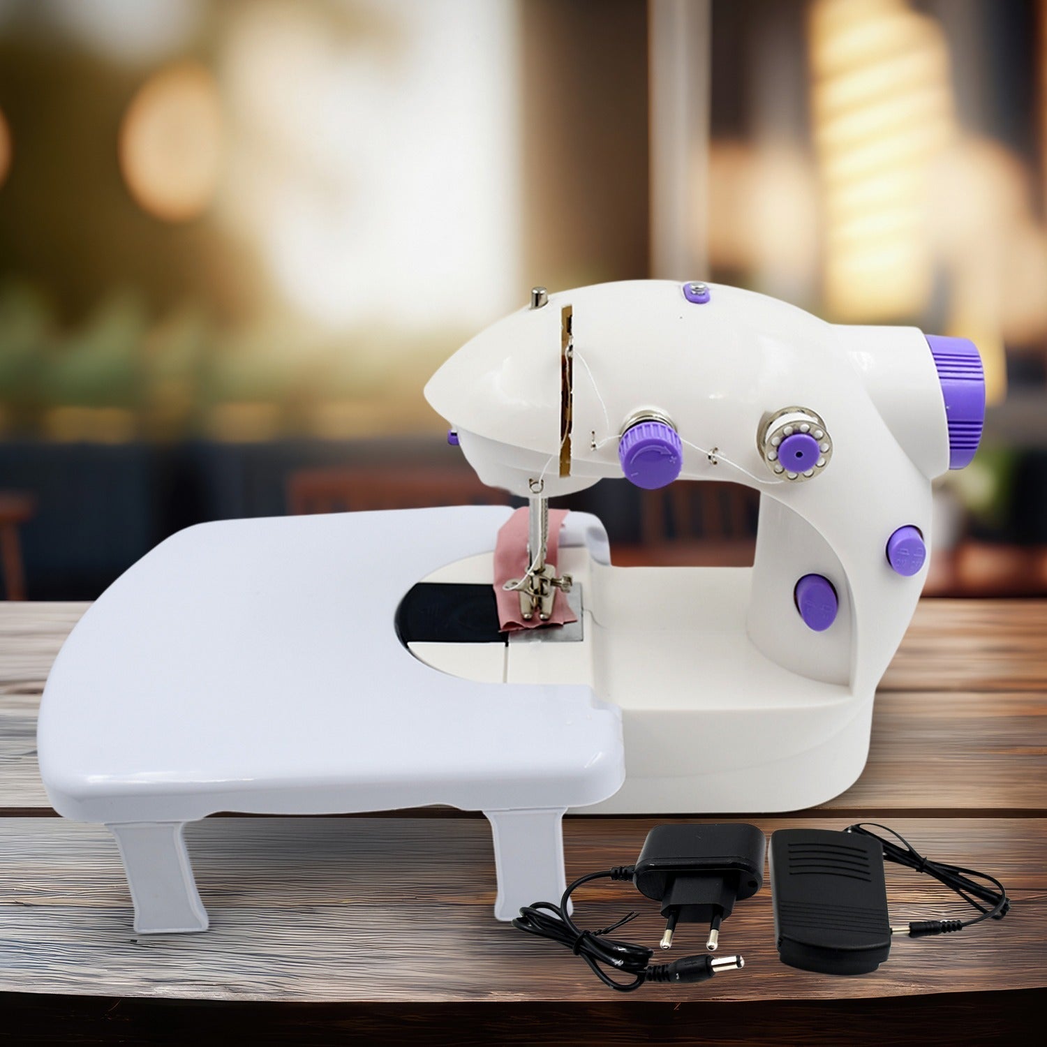 Mini Sewing Machine with extension table, foot pedal, and adapter on a clean surface.