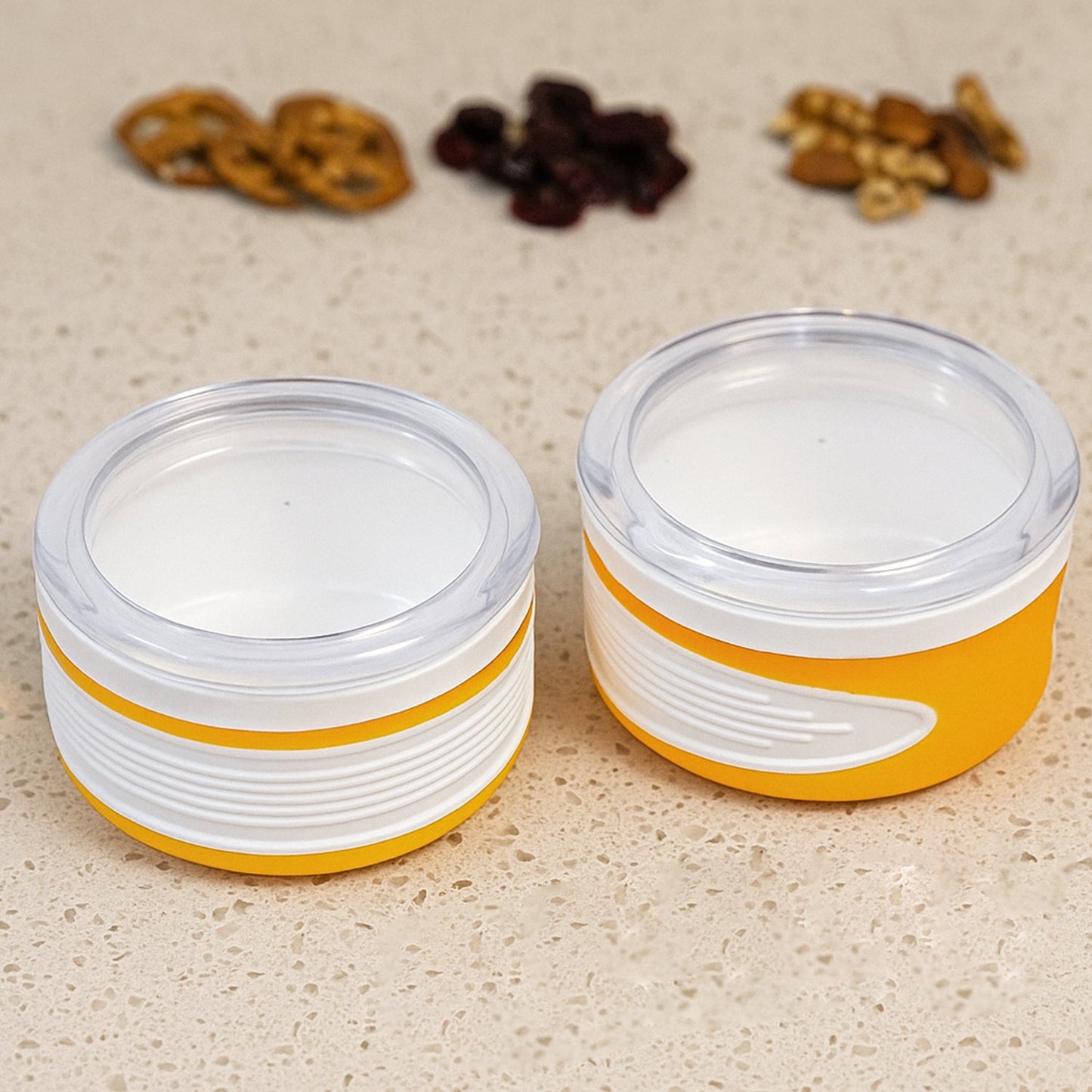 Two clear plastic airtight food containers with blue lids, stacked neatly.