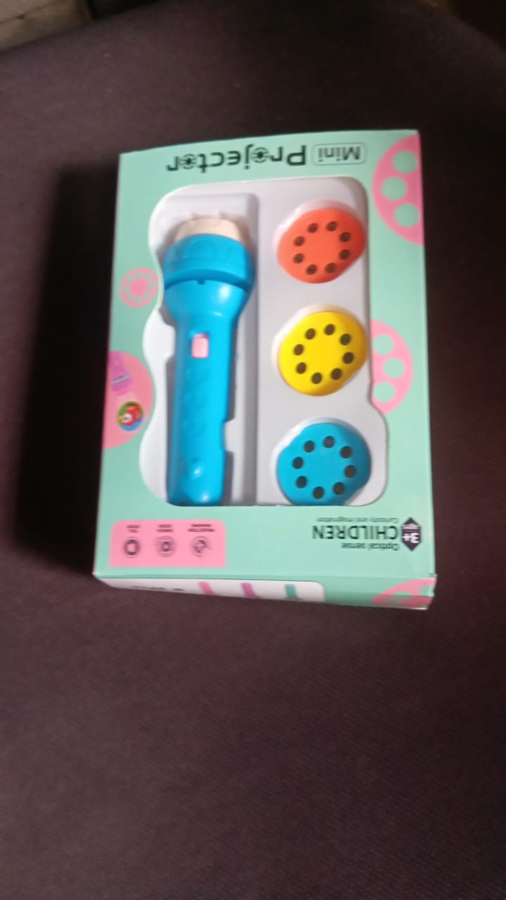 Children excitedly playing with the Mini Slide Projector, enjoying the projected image on a wall.