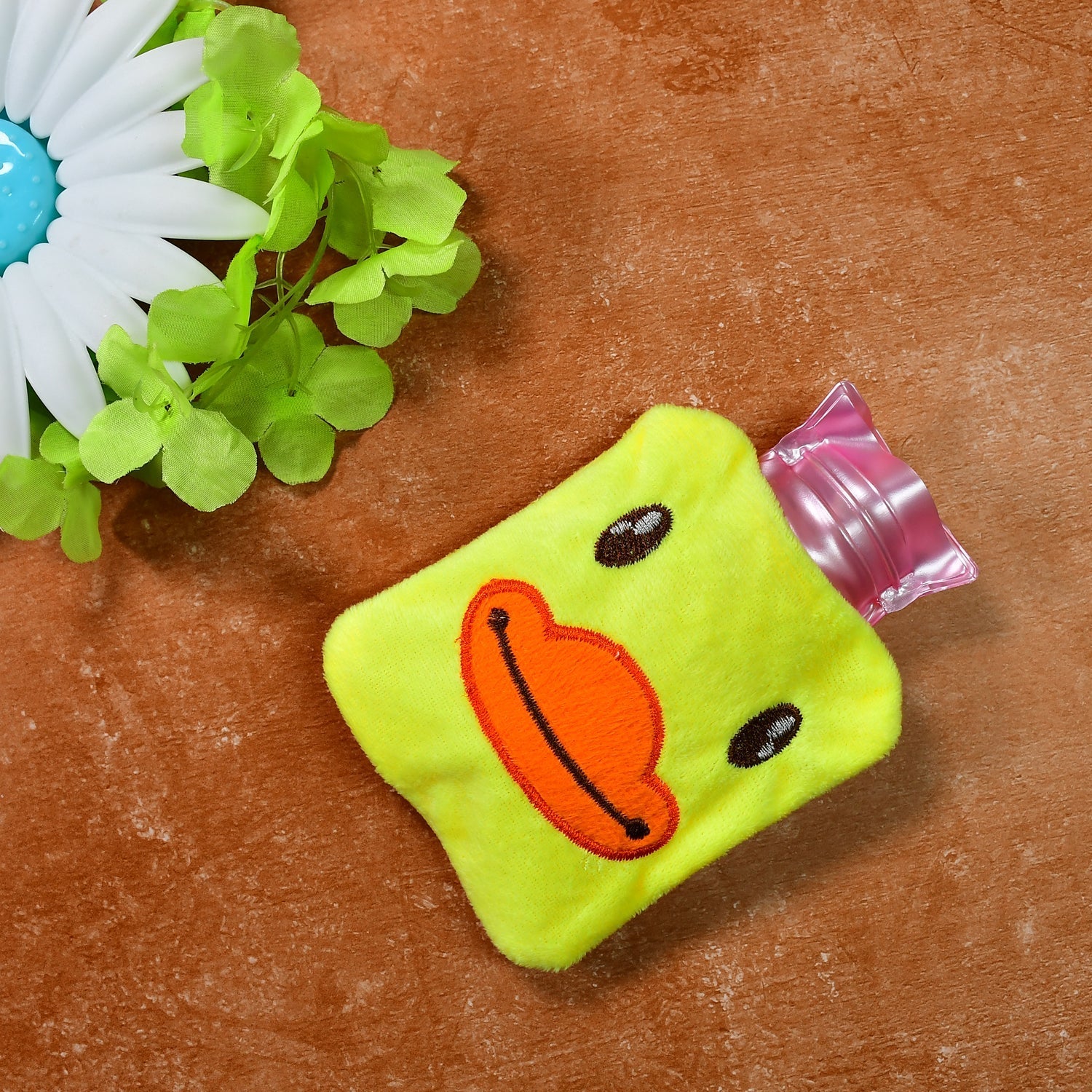 Yellow duck hot water bag with soft cover for pain relief.
