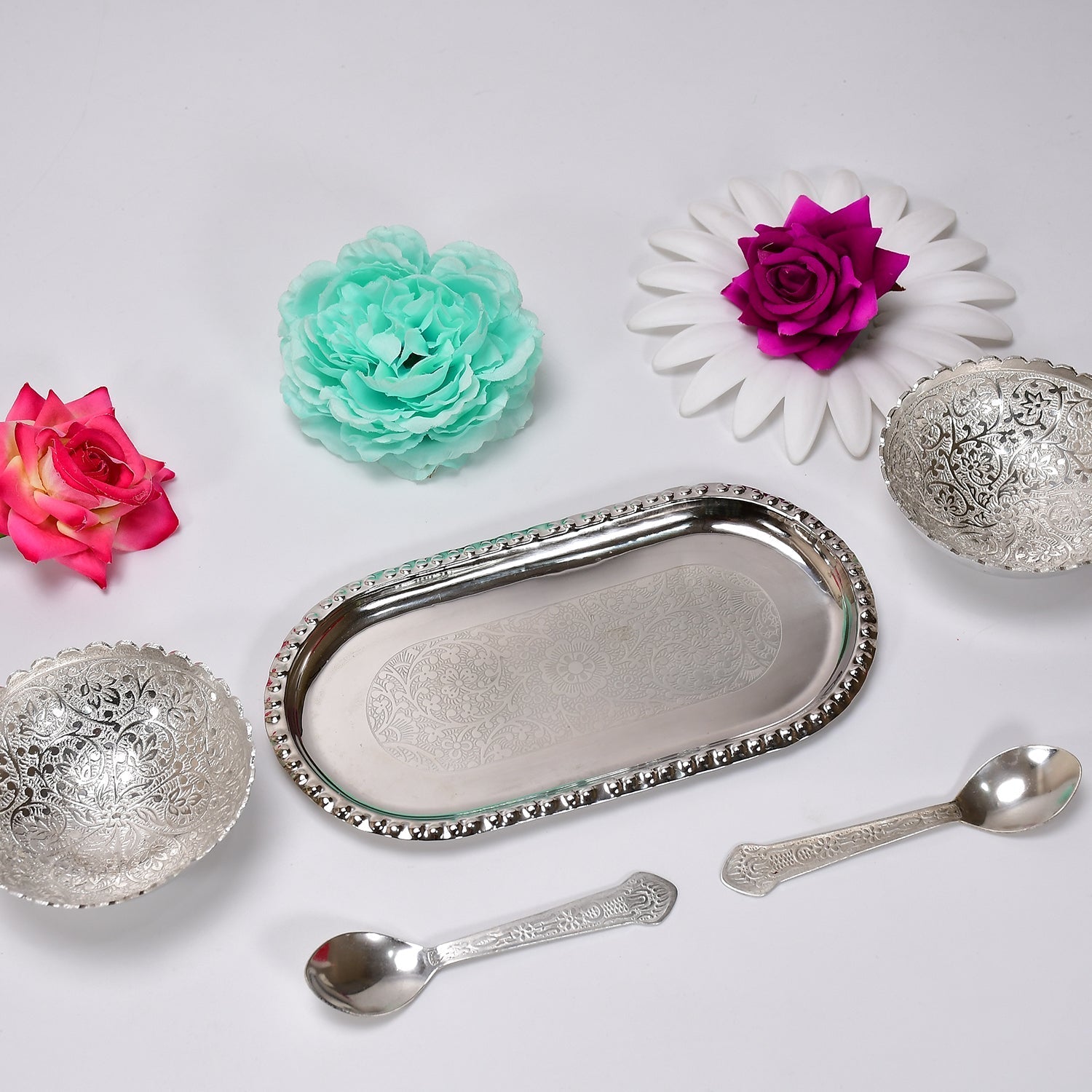 A beautiful serving set featuring two silver plated bowls and spoons, designed for traditional Indian hospitality.