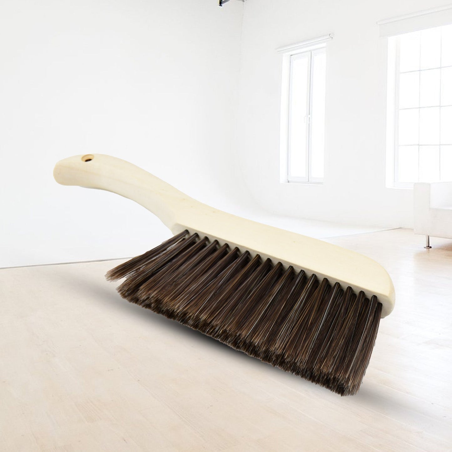 Versatile brush for removing small particles, lint, and pet hair from various fabric surfaces.