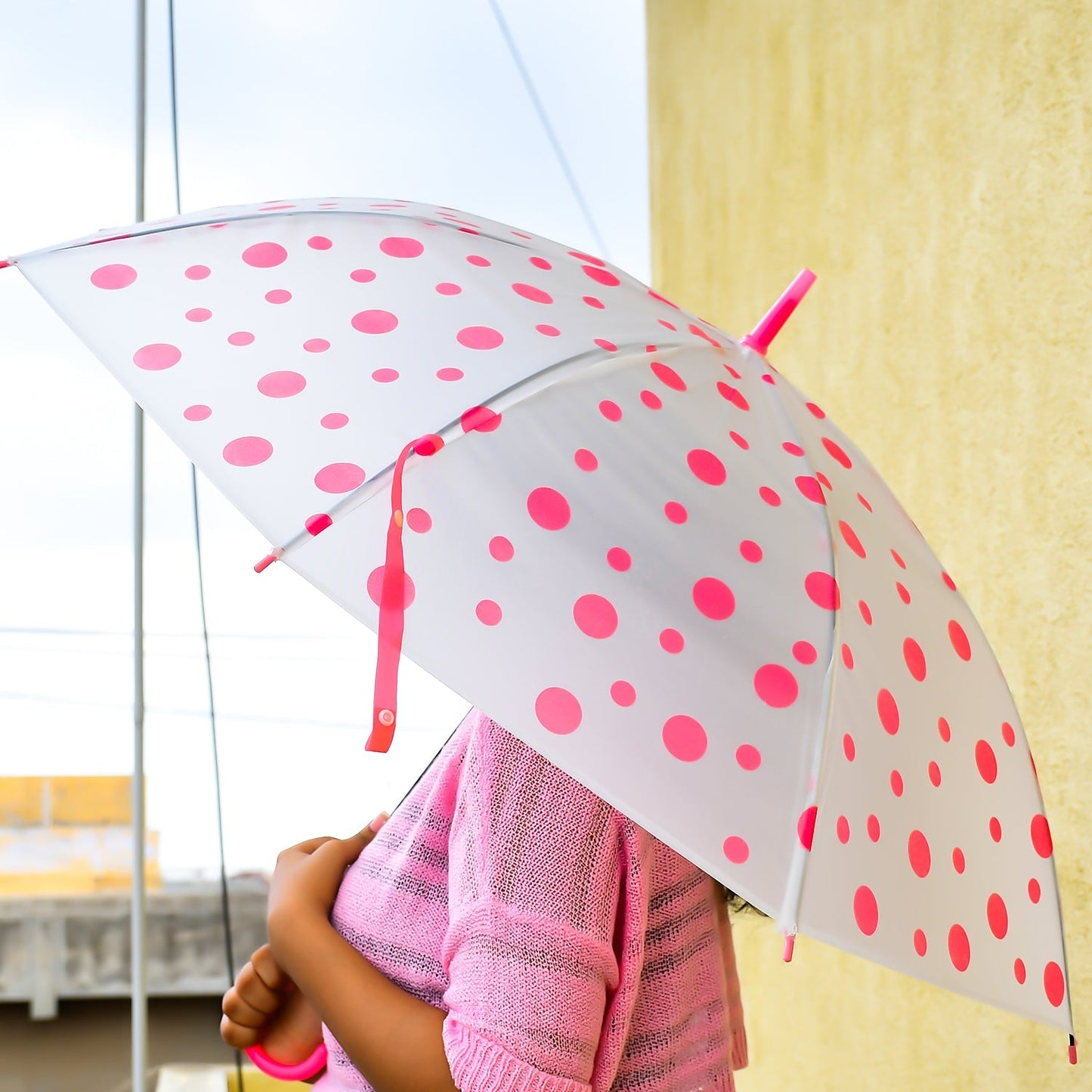 Multicolor dot printed umbrella with automatic opening mechanism, ready for use.