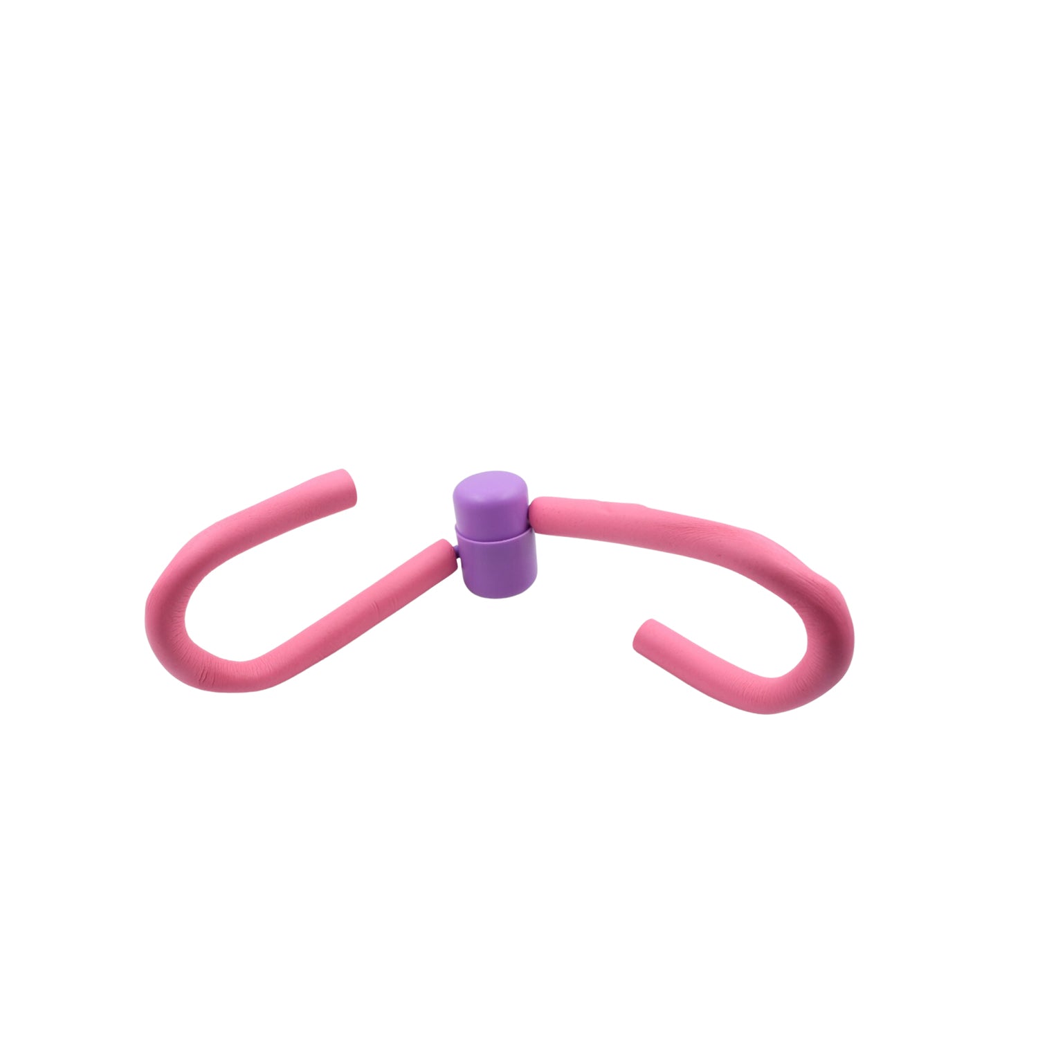 The Thigh Toner positioned next to other gym equipment, highlighting its compact size.