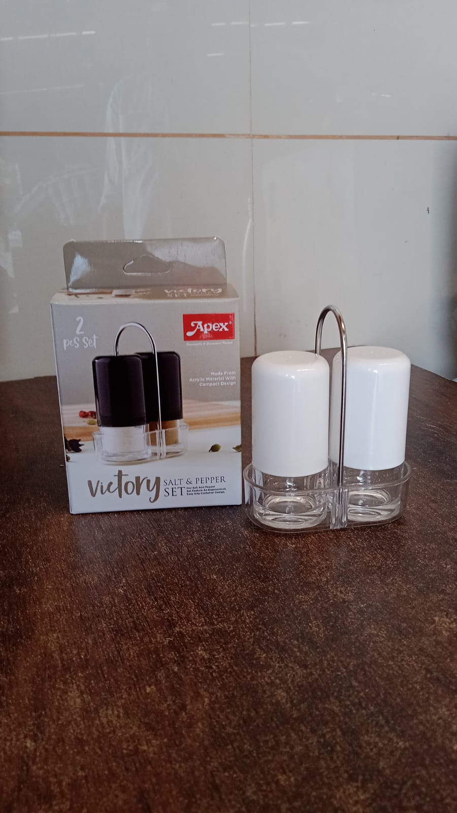 Salt and pepper seasoning dispensers placed neatly on kitchen counter