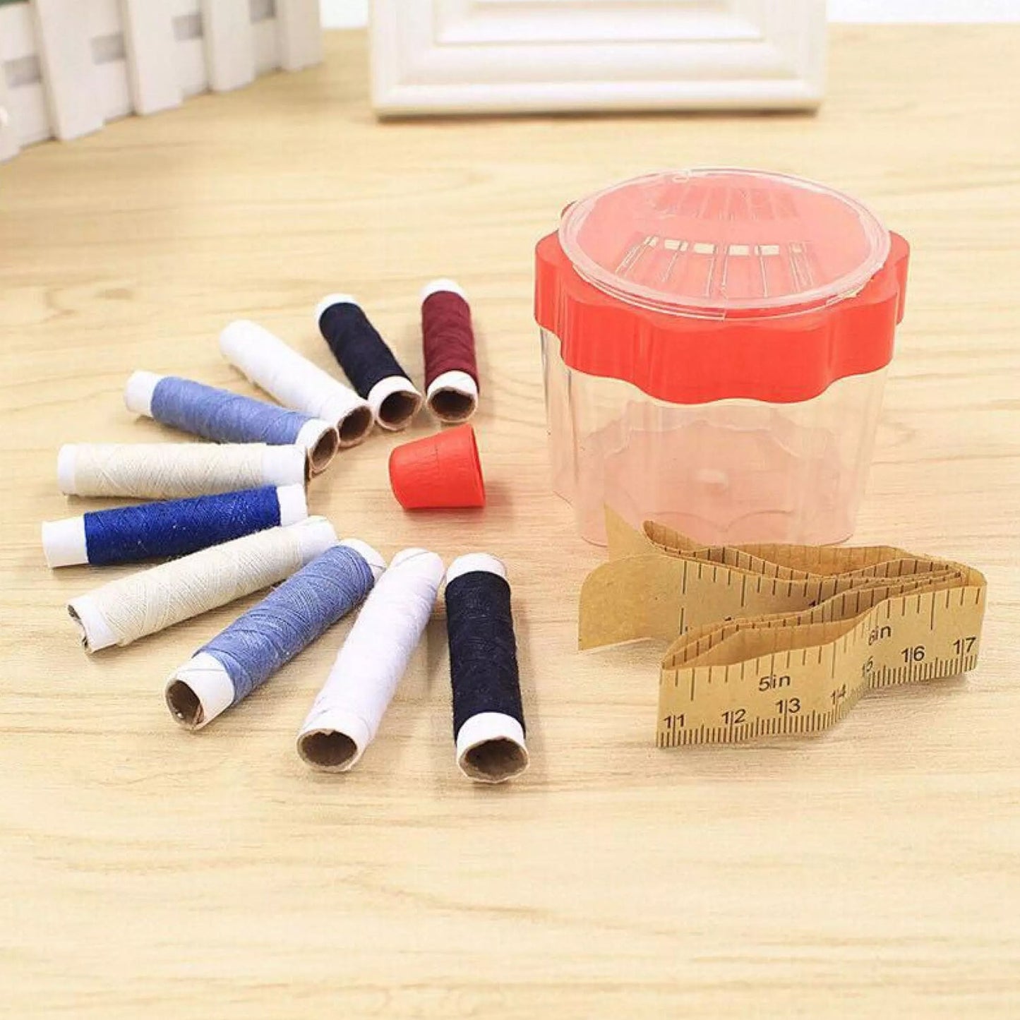 A complete sewing box showcasing arranged threads, buttons, and essential tools.