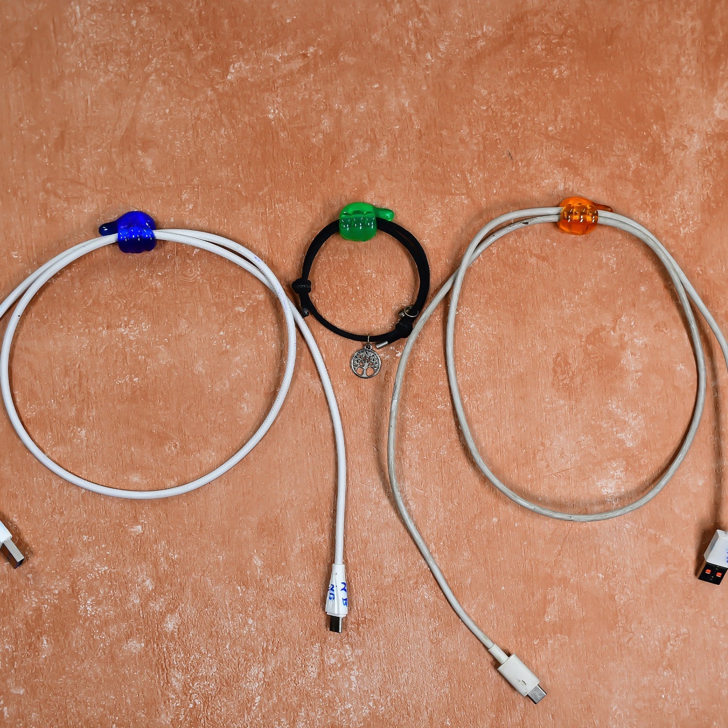 Multiple hand shape wall clips demonstrating their use for organizing small household items.