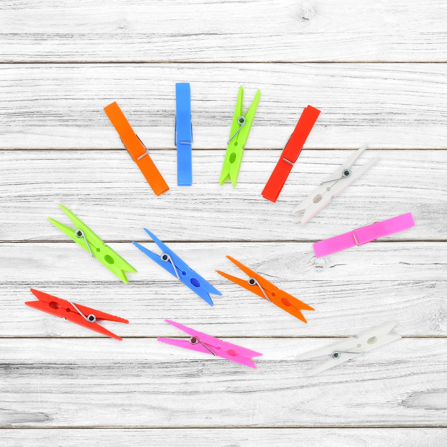 Stack of colourful plastic clothes clips for home and laundry use.