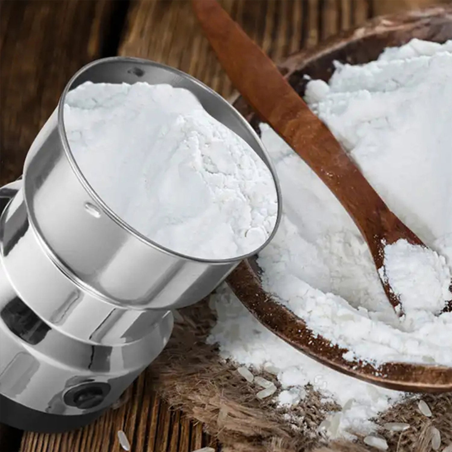 Hand operating the compact electric spice grinder with transparent lid.