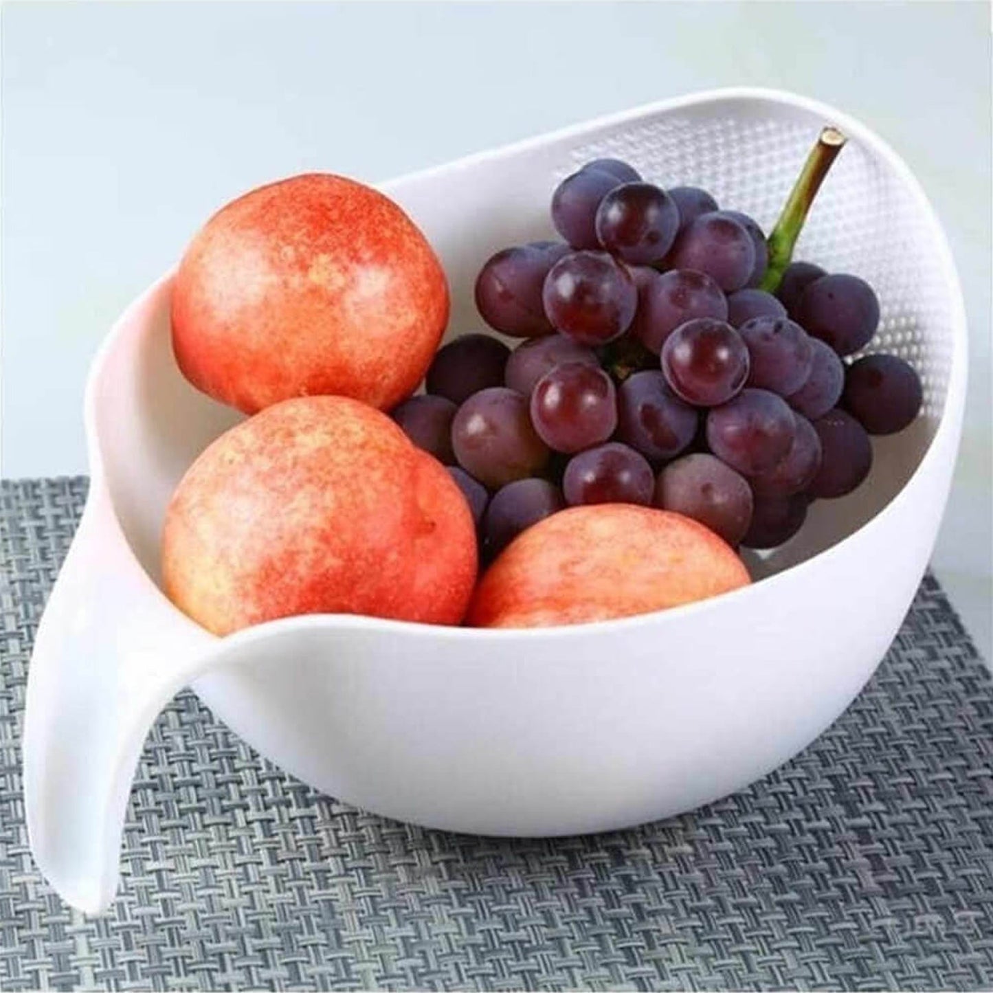 Multi-purpose plastic food strainer with a sturdy handle for various kitchen tasks.