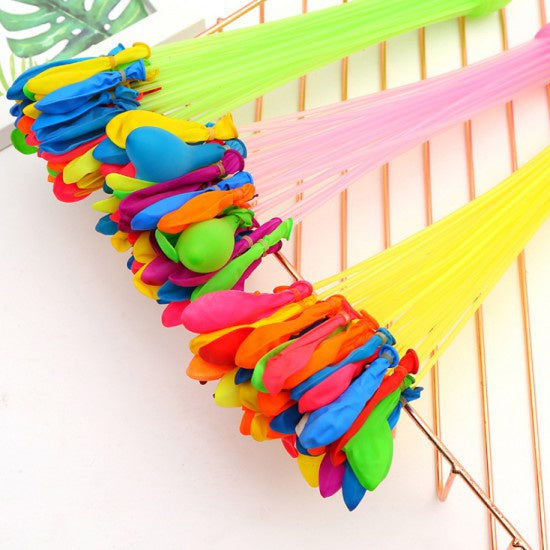 Multiple bunches of self-sealing Holi water balloons attached to a tap.
