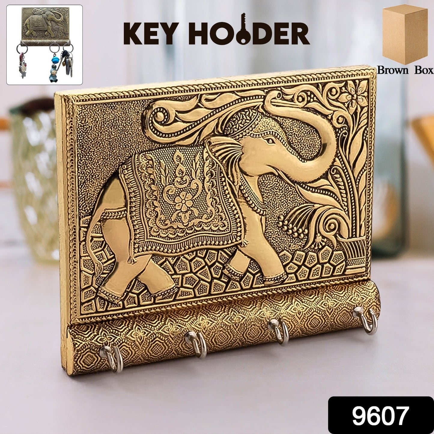 Close-up of the polished gold elephant head and hooks on the wooden key holder.