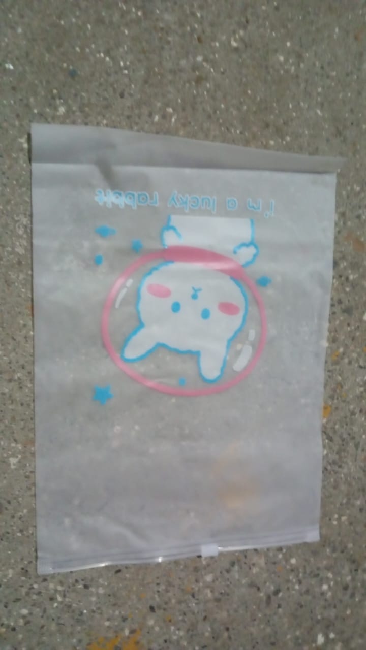 Reusable zip pouch filled with cosmetics, demonstrating its utility as a makeup bag.