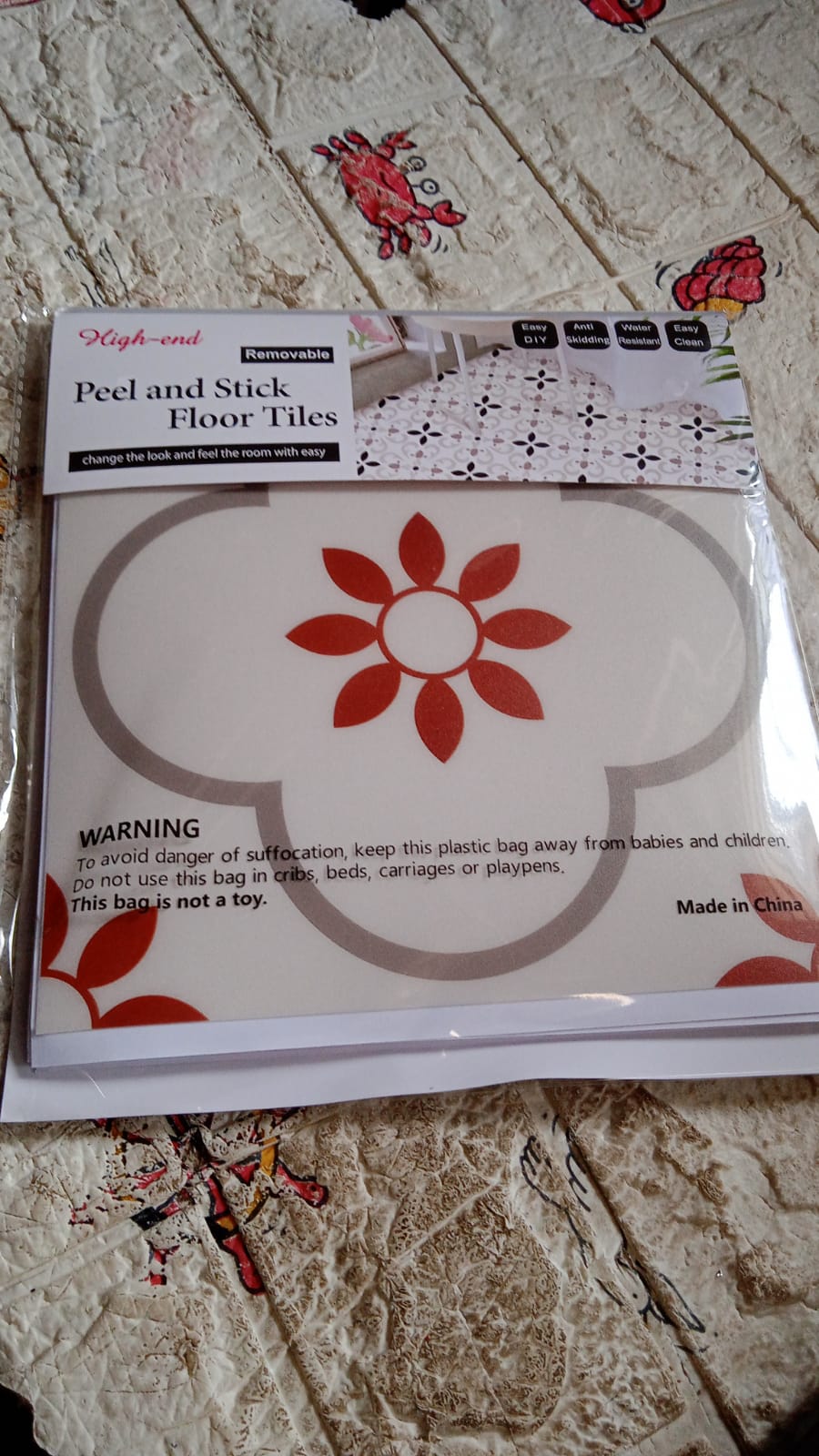 Stack of waterproof vinyl tile sticker sheets ready for home decoration projects.