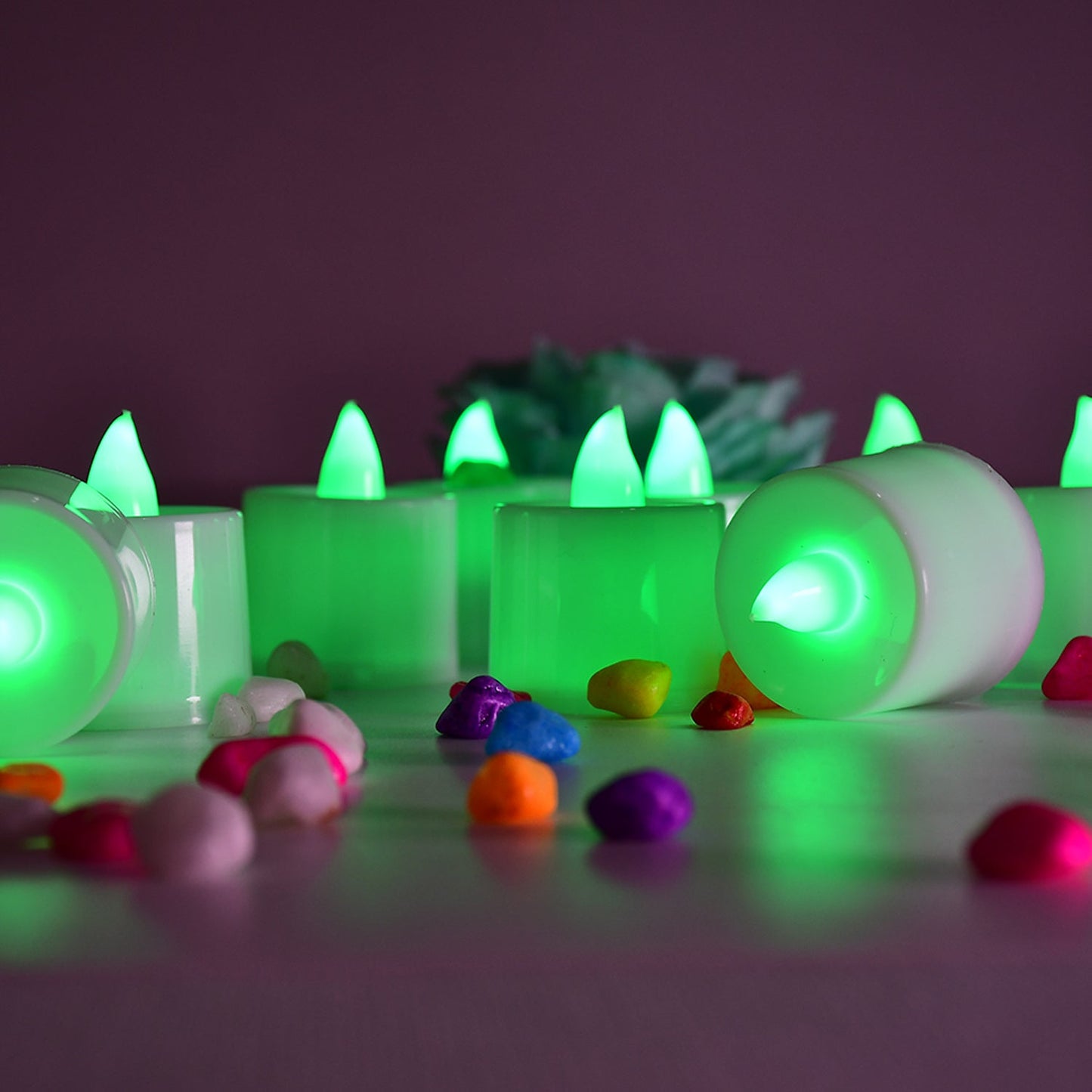 Several green LED flameless candles illuminating a space.